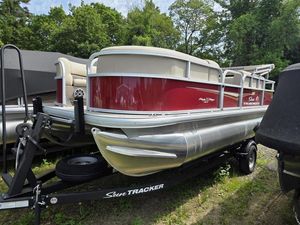 2025 Sun Tracker PB 18 DLX pontoon boat on trailer, red and silver design.