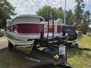 2025 Sun Tracker PB 18 DLX pontoon boat on trailer, displayed outdoors.