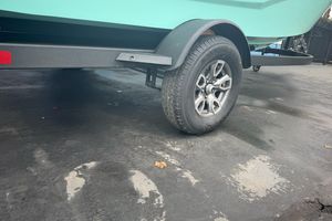 Trailer wheel of 2026 Tahoe T18 boat on pavement.