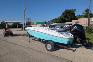 2026 Tahoe T16 boat on trailer, parked near a rural gas station.