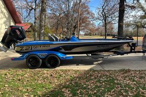 2024 Nitro Z21 XL Pro boat on trailer, parked outdoors in a wooded area.