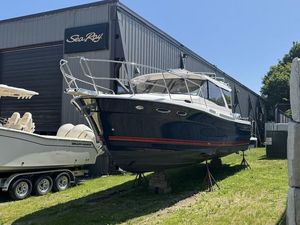 2023 Cutwater C32 Coupe boat displayed outside Sea Ray building.