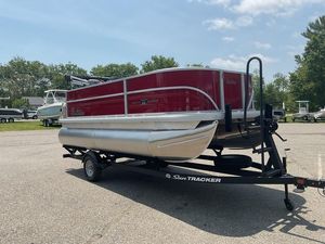 2026 Sun Tracker PB 16 DLX pontoon boat on trailer in parking lot.