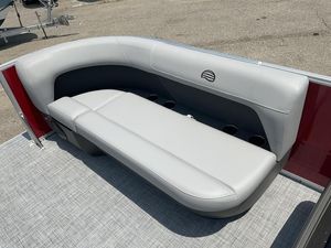 2026 Sun Tracker PB 16 DLX boat with sleek gray seating and cup holders.