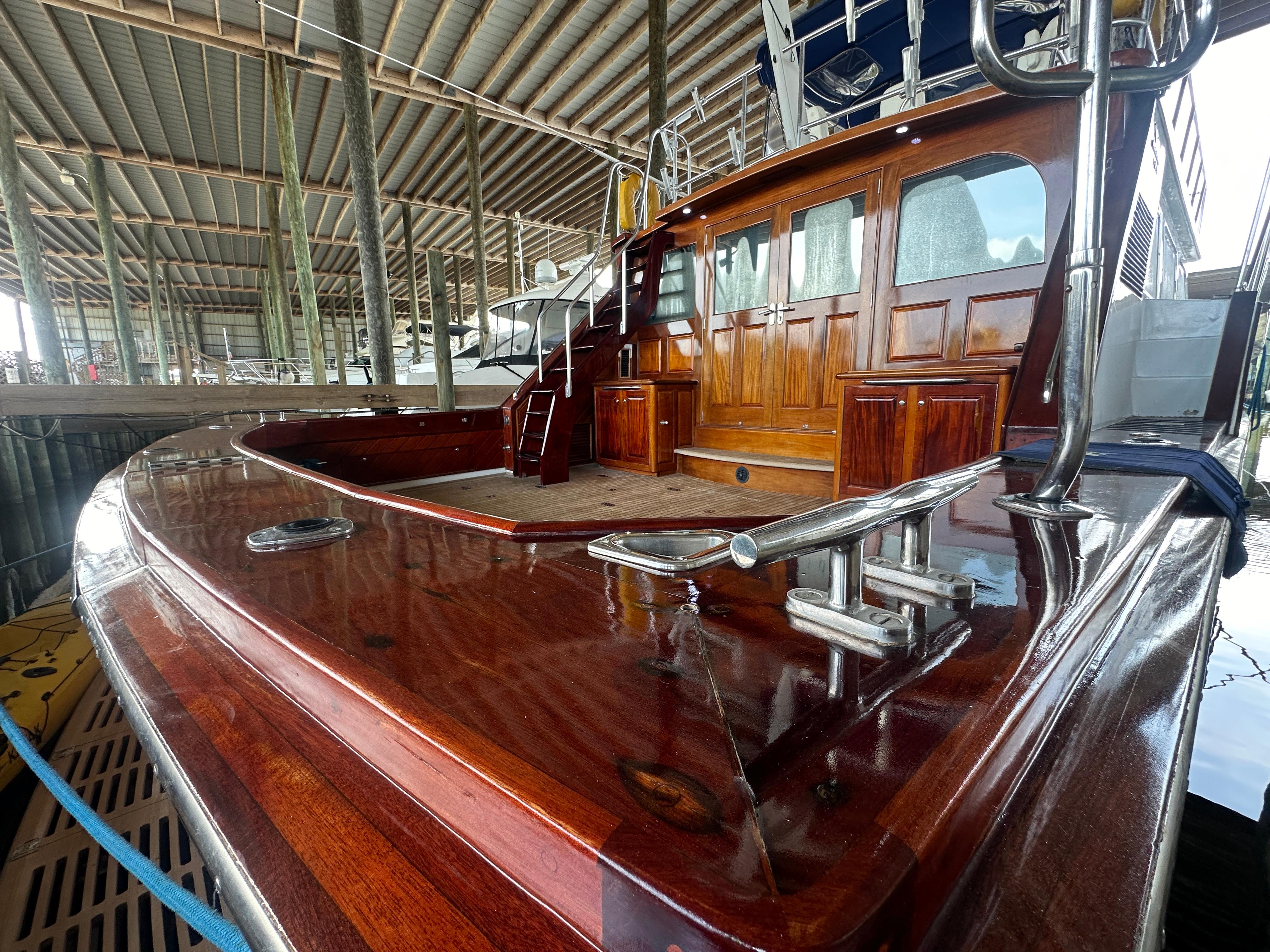 Bertram-58 Convertible Custom Total Rebuild 2010 1980-Liberty Belle TX-US-1980 Bertram 58 Convertible Custom yacht with polished wood deck in marina.-9430006 | Thumbnail