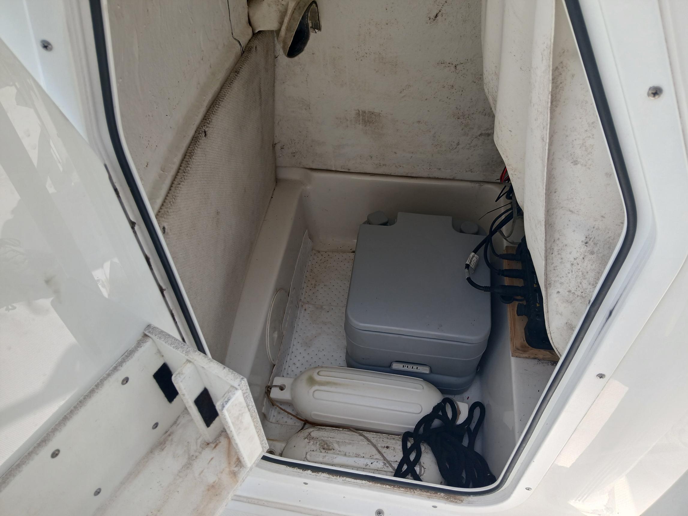 2014 Sea Hunt BX 22 BR storage compartment with equipment and accessories.