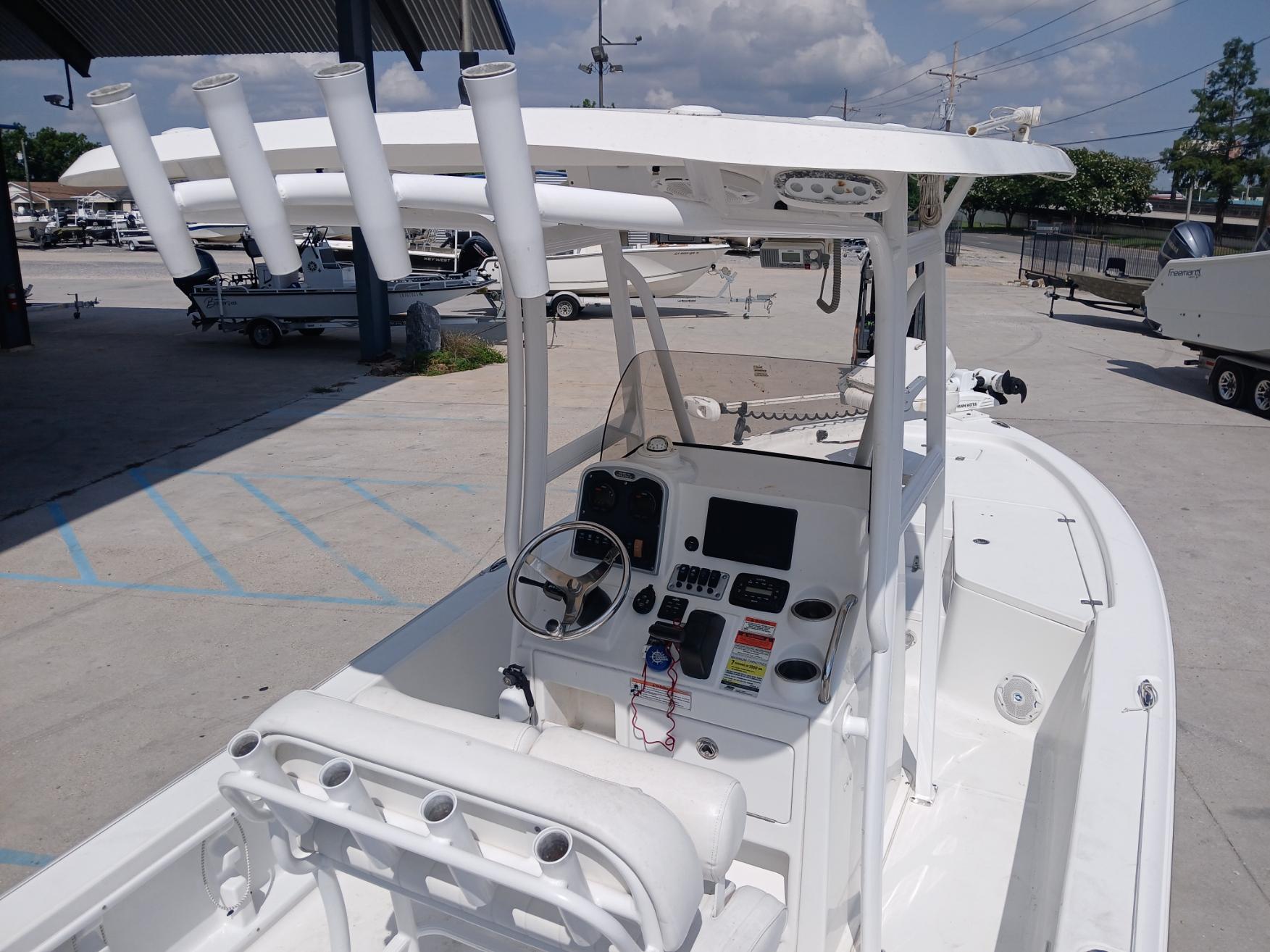2014 Sea Hunt BX 22 BR boat with center console and rod holders, parked outdoors.