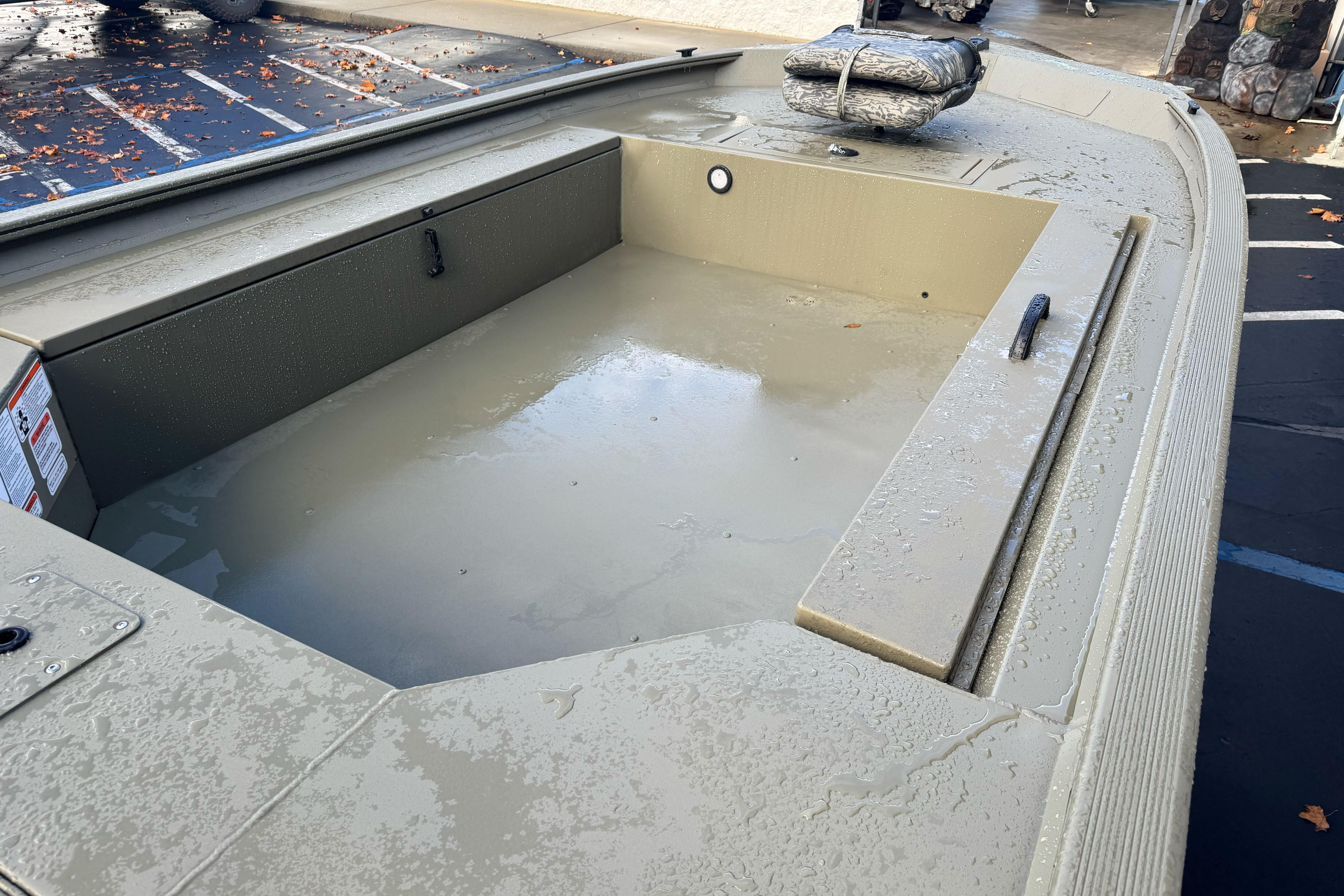 2026 Tracker Grizzly 1654 T Sportsman boat interior with storage compartment and textured surface.