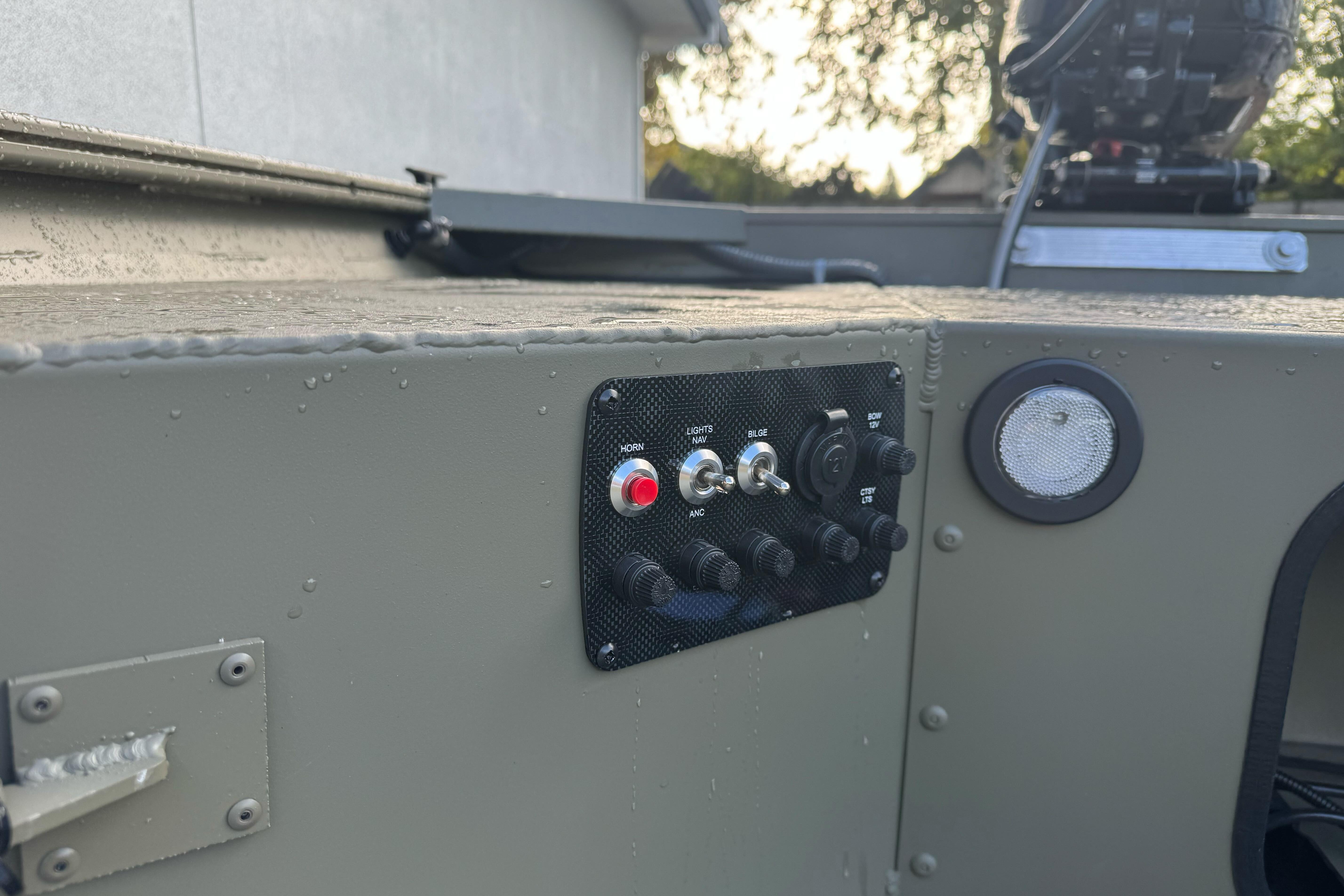 Control panel on 2026 Tracker Grizzly 1654 T Sportsman boat, featuring switches and buttons.