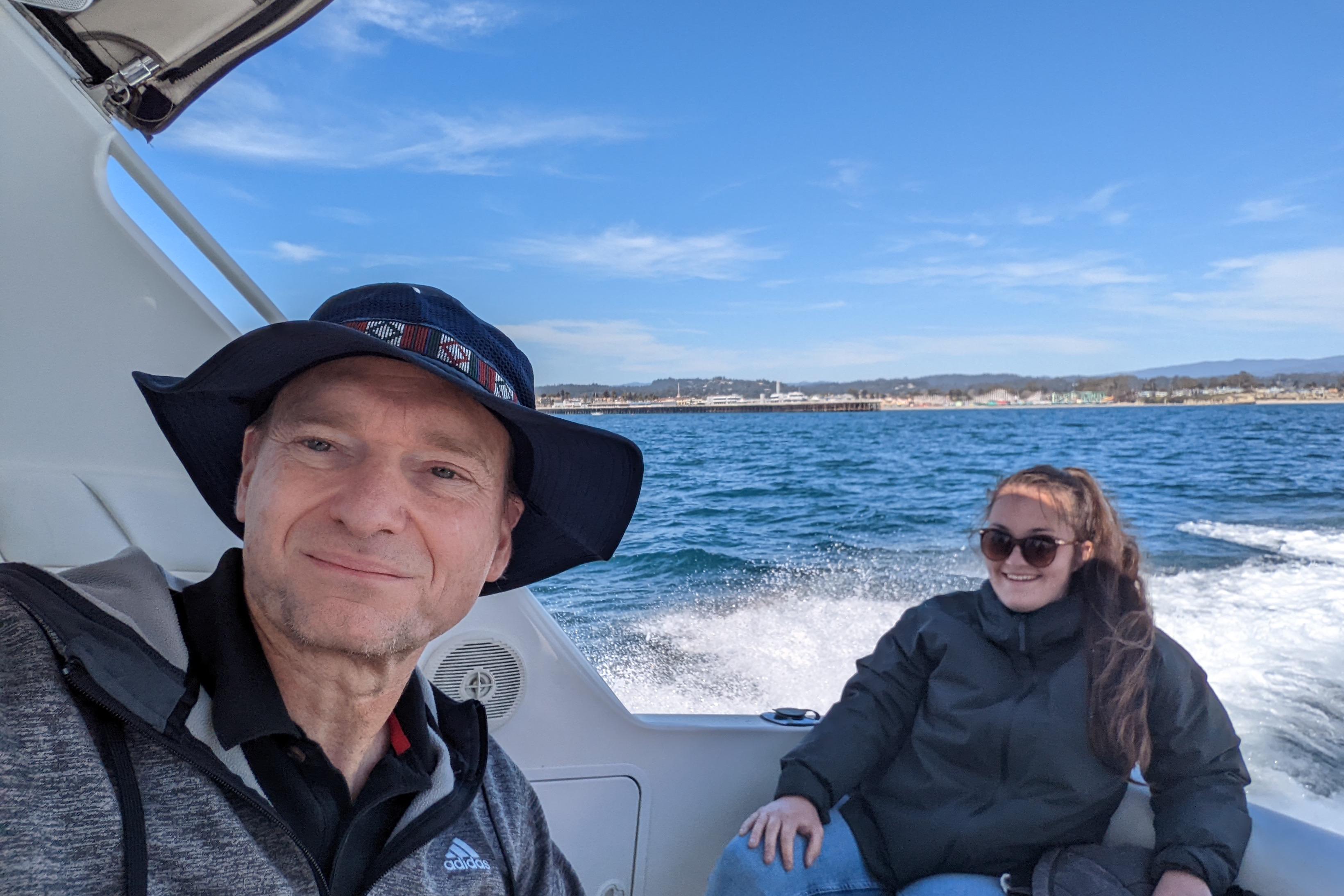 Man and woman enjoying a boat ride on a 1999 Mainship Pilot 30.