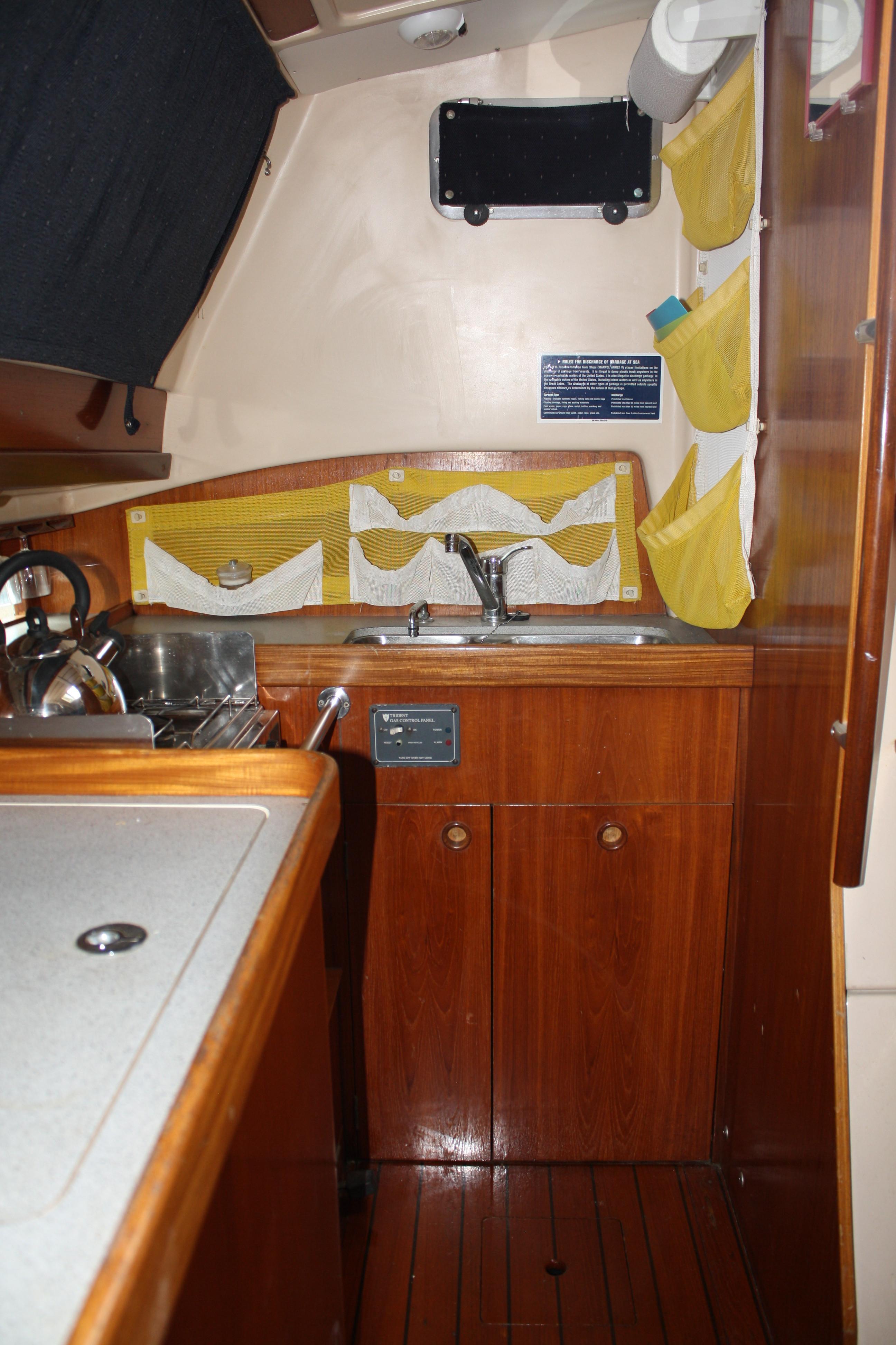 The majority of the galley is to starboard and just aft of the companionway with easy access to the large fridge and freezer
