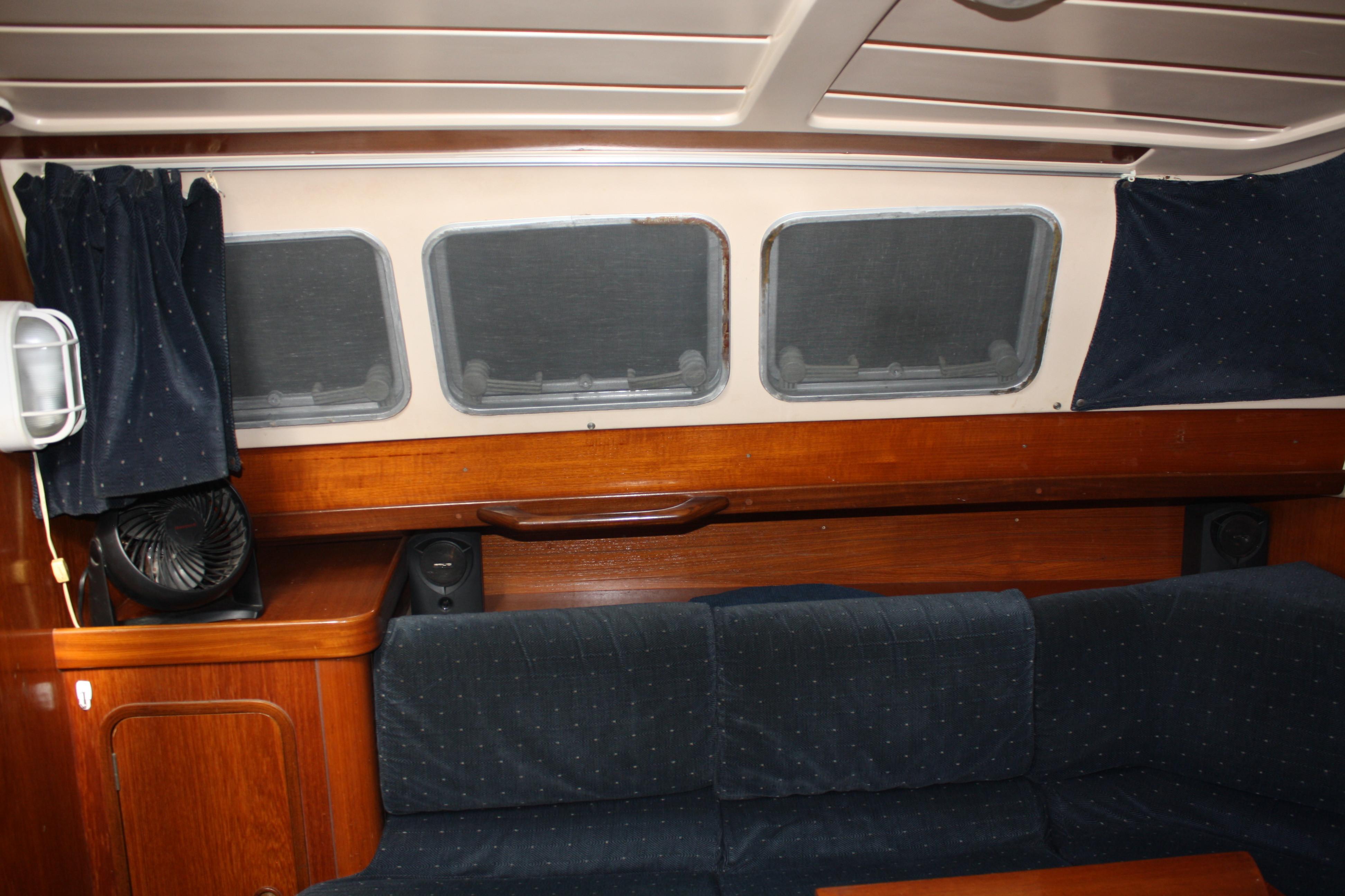 Pulling back the interior curtains reveals a few of the opeining ports in the main saloon. Unfortunately they are covered on the outside as well. At least you know the owners take good care of their boat.