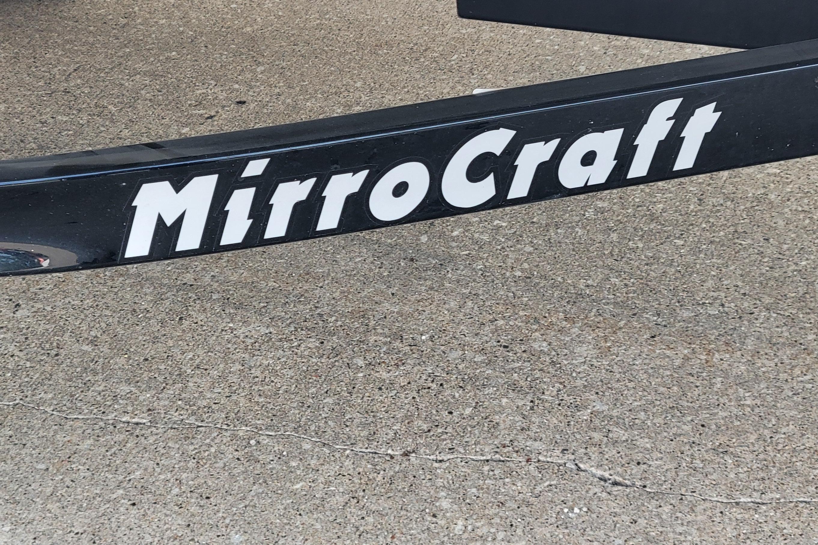MirroCraft 1400 boat trailer, 2014 model, black with white lettering on concrete surface.