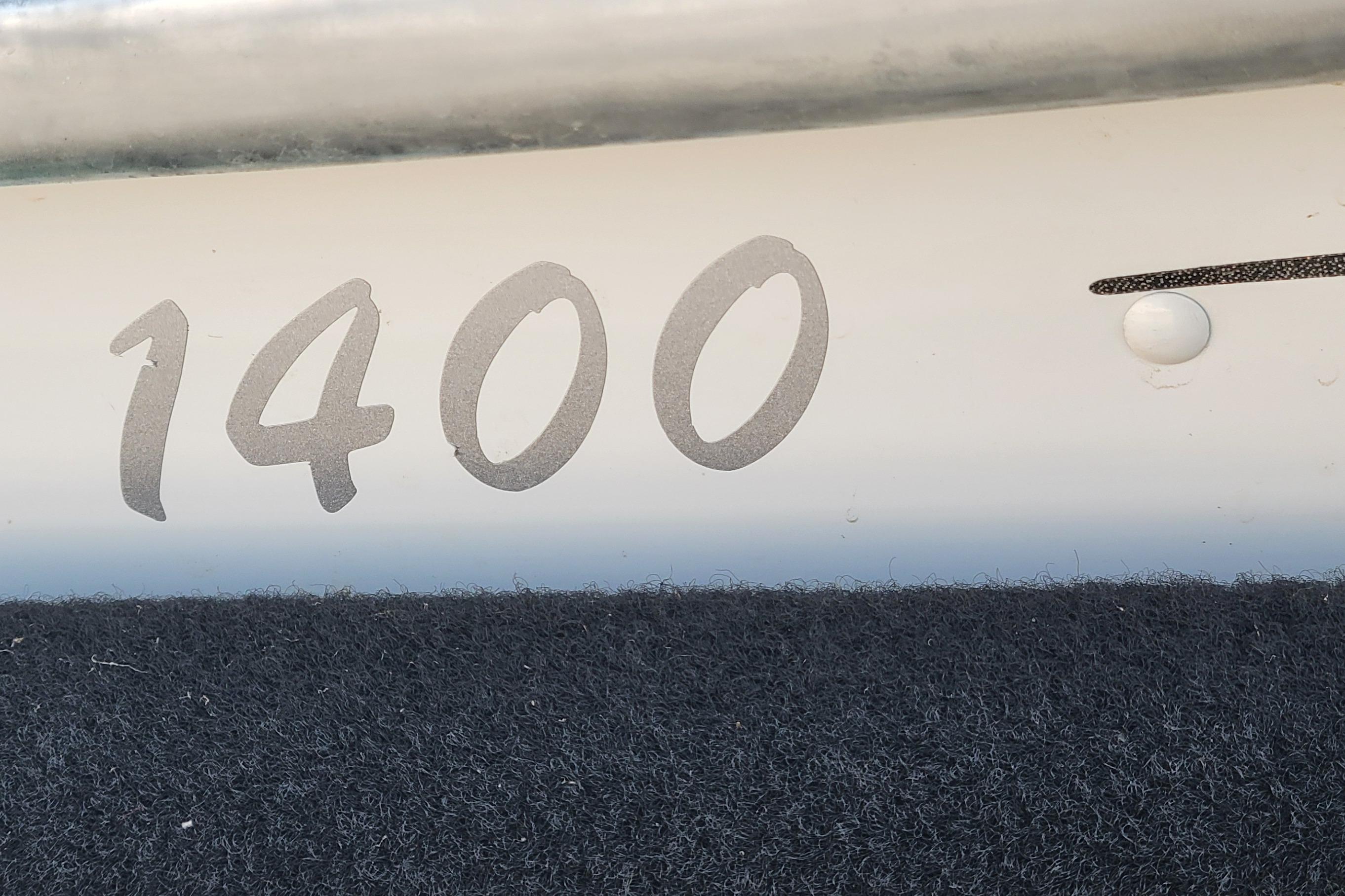 Close-up of 2014 MirroCraft 1400 boat model number on hull.