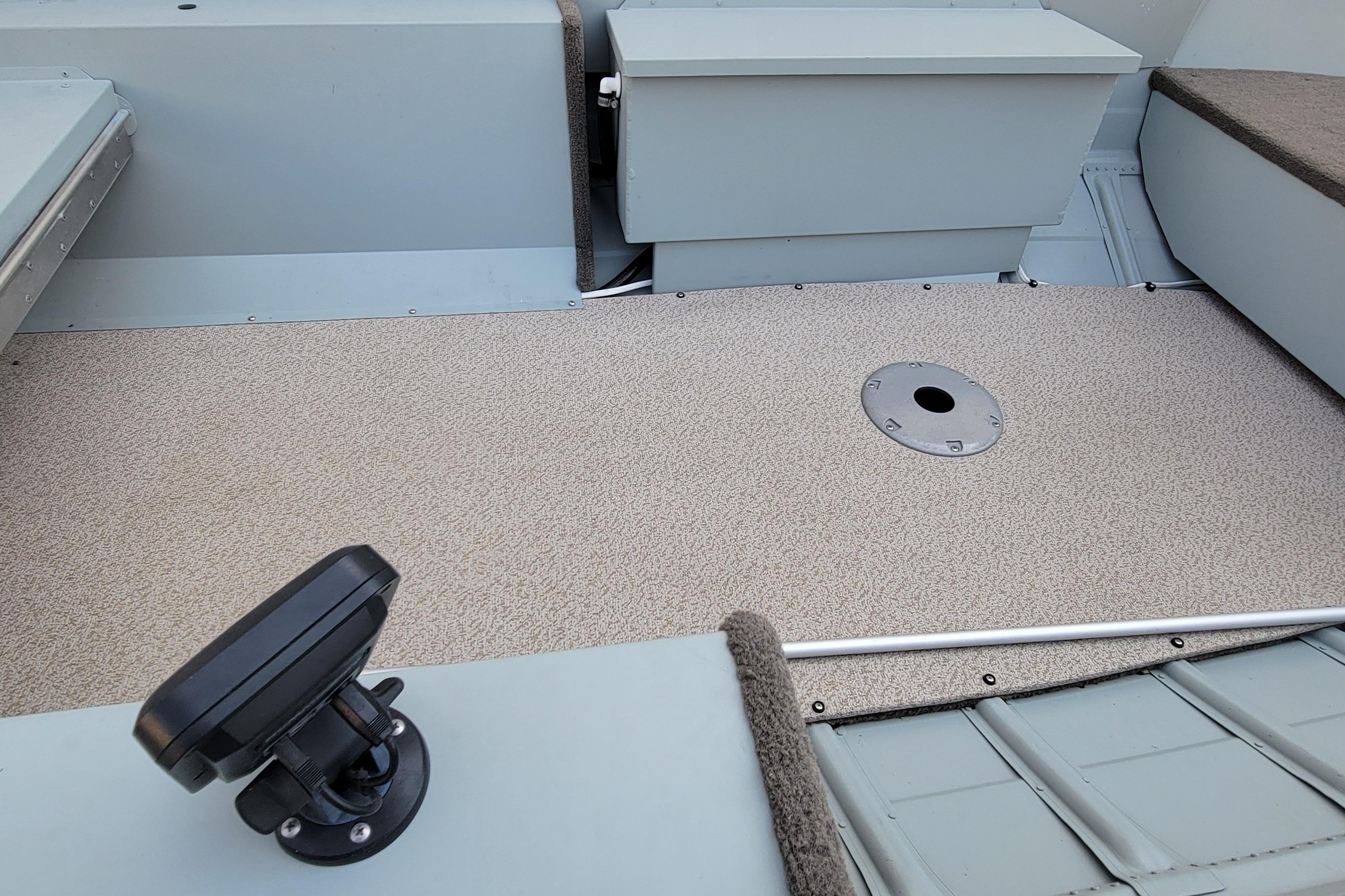 Interior of 2014 MirroCraft 1400 boat showing seating and deck details.