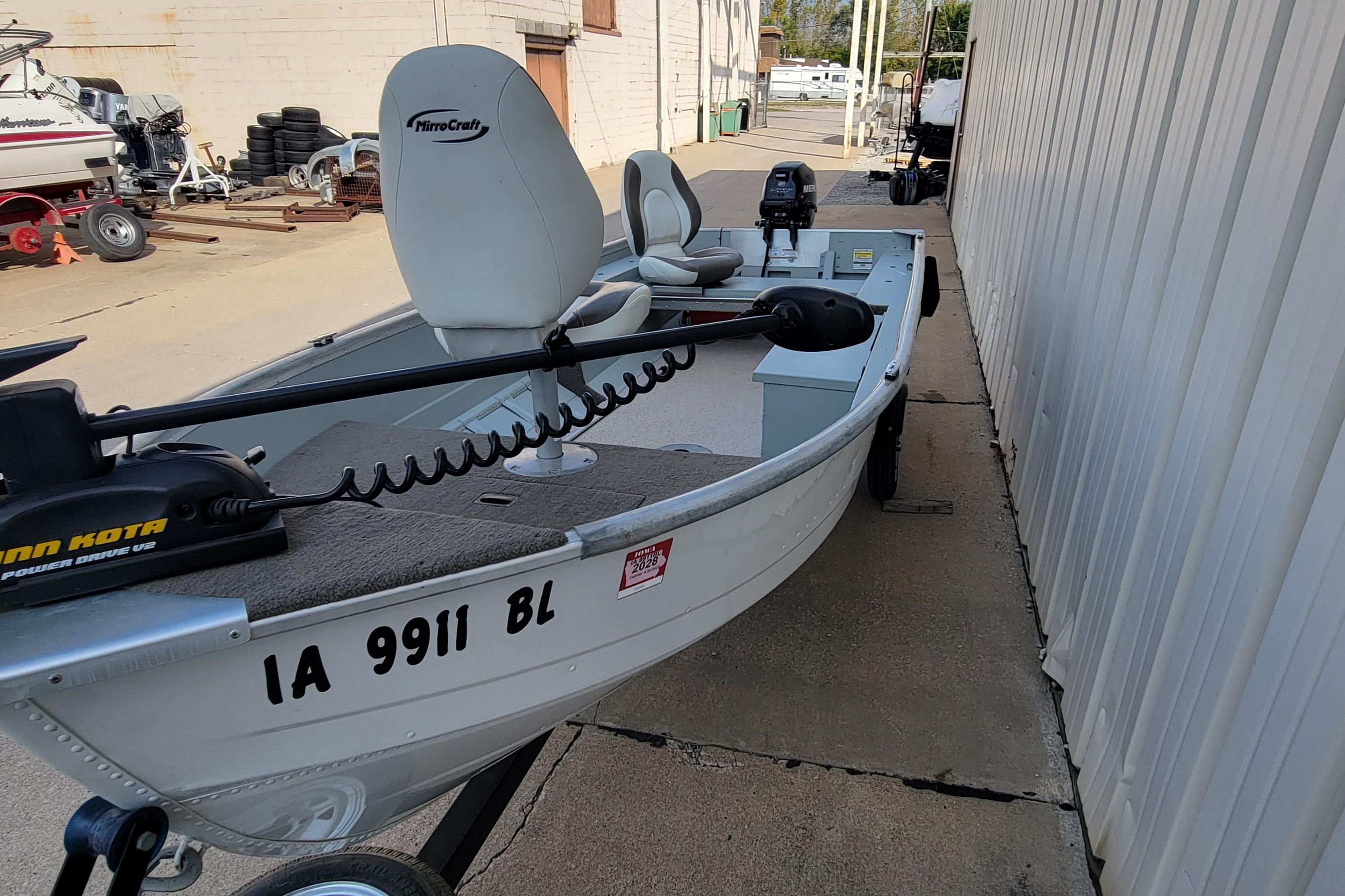 2014 MirroCraft 1400 boat with Minn Kota motor, parked on a trailer.