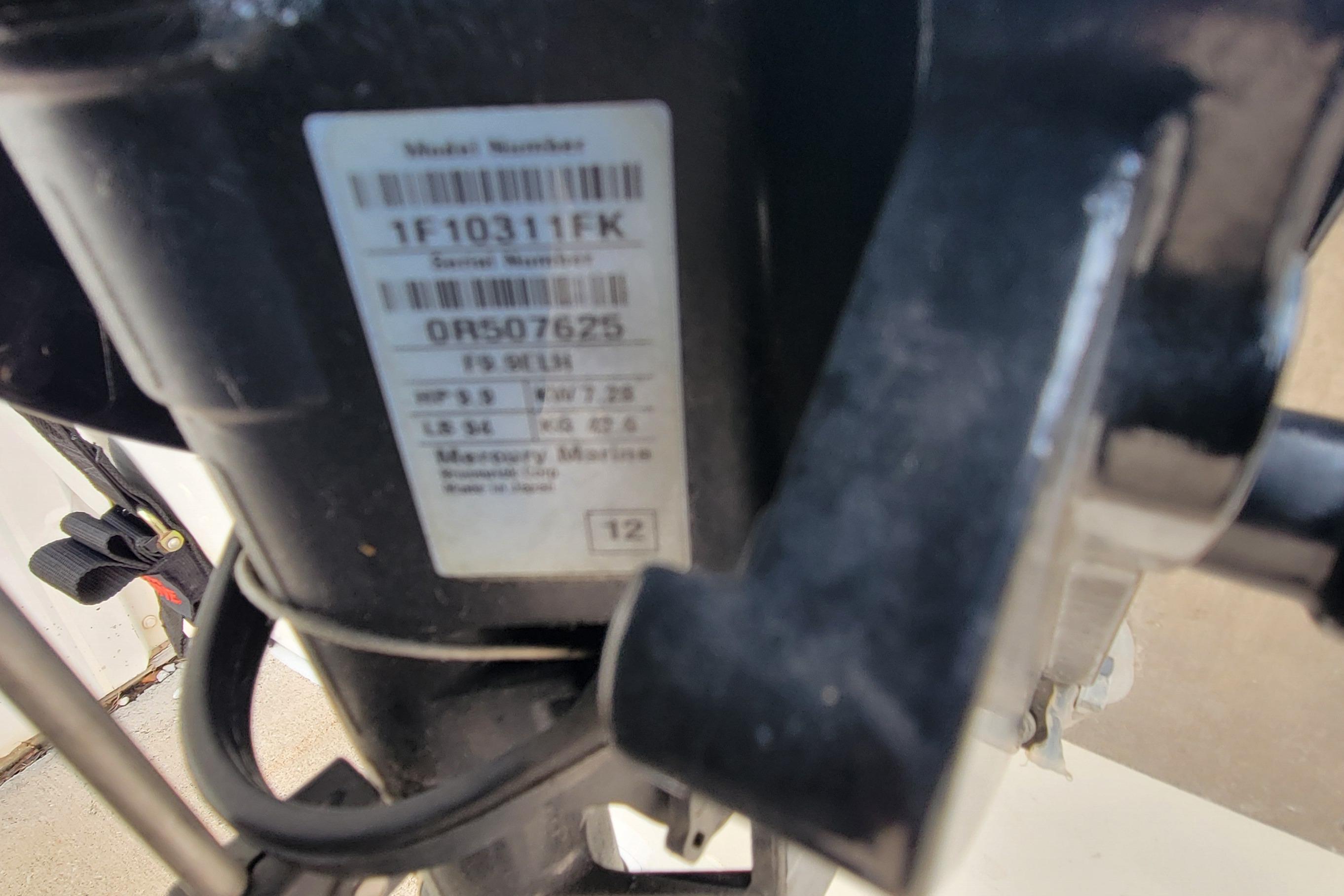 Close-up of a Mercury Marine engine label on a 2014 MirroCraft 1400 boat.