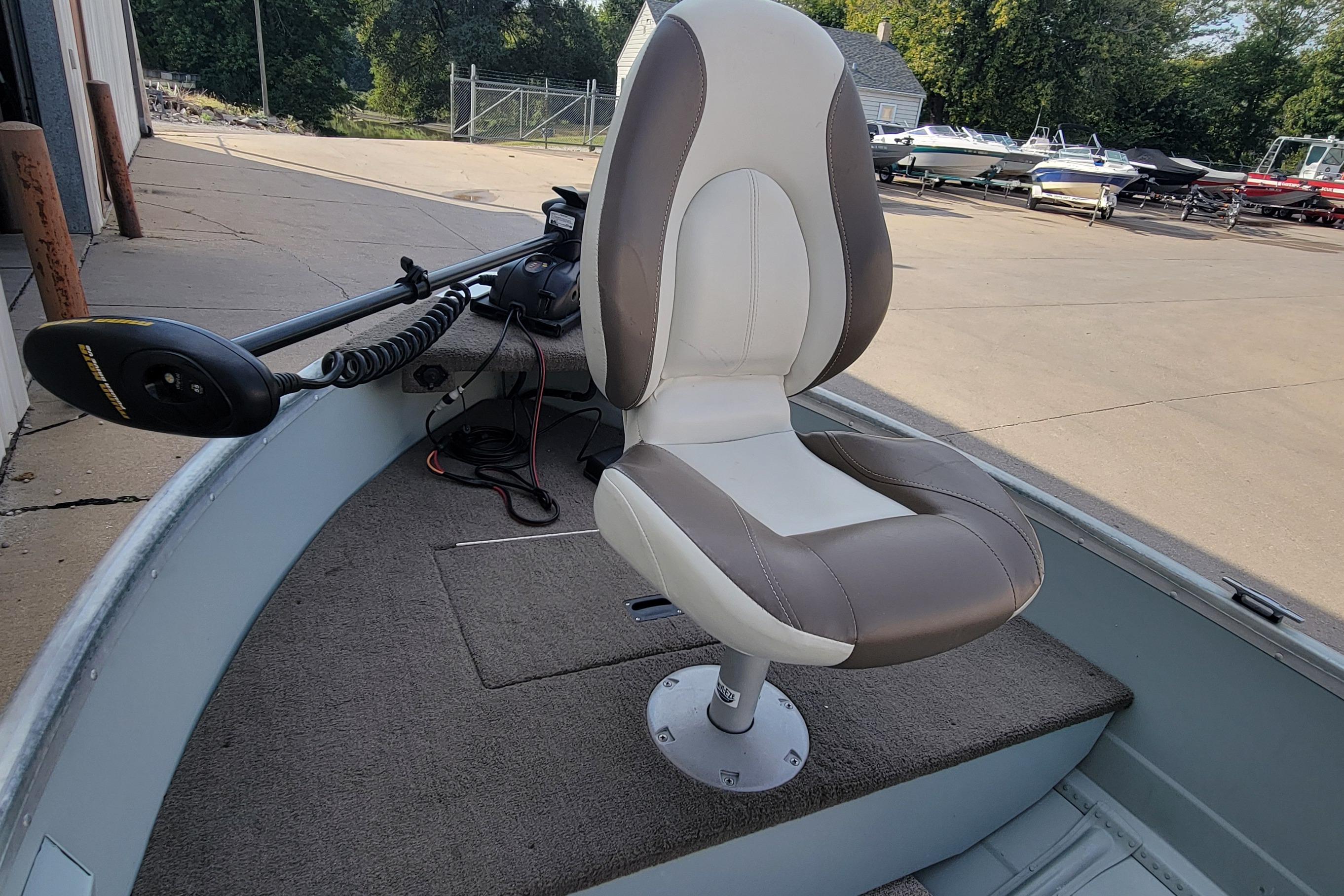 2014 MirroCraft 1400 boat with a swivel seat and trolling motor.