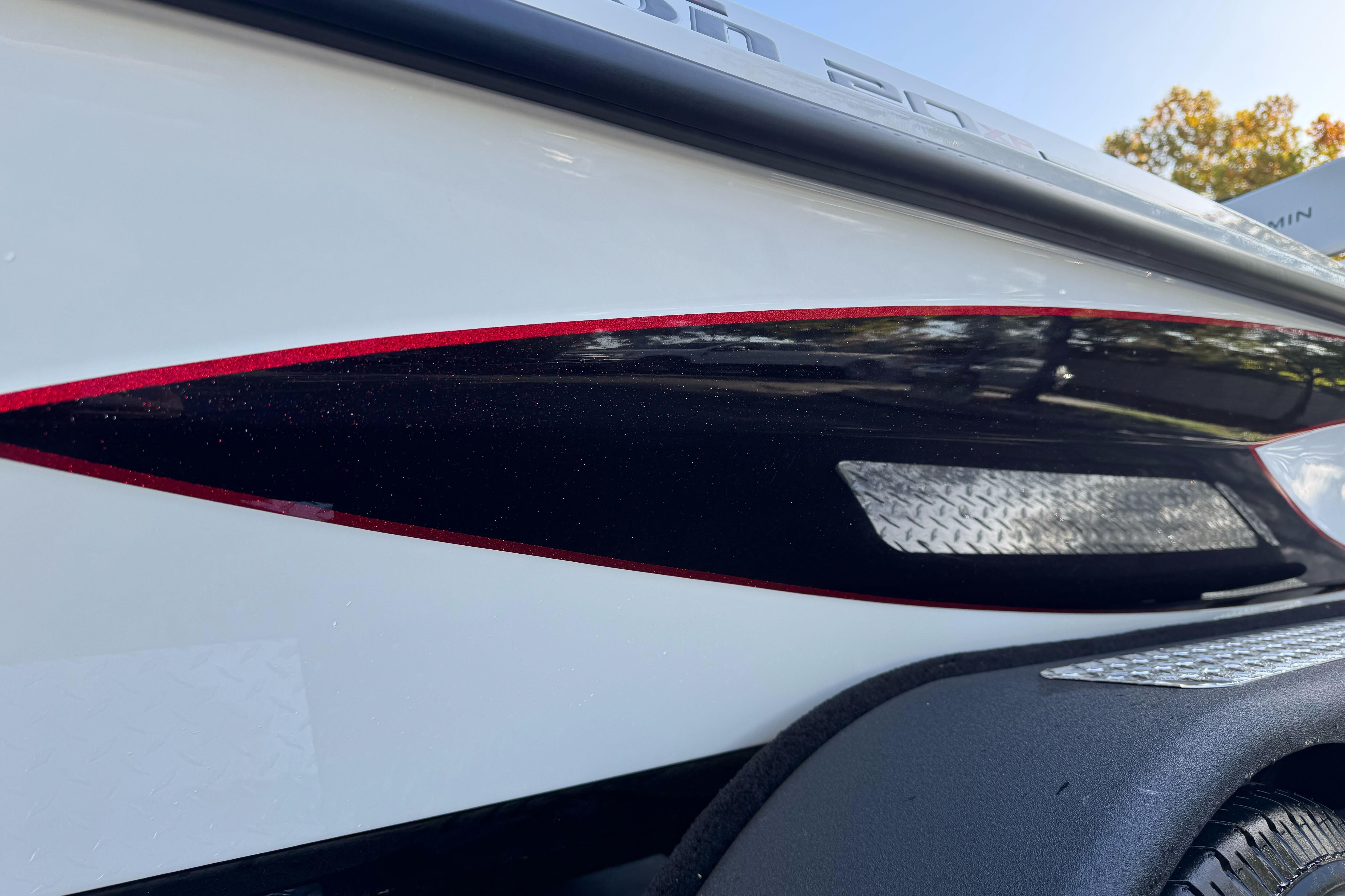 2026 Triton 20XP Patriot boat with sleek red and black detailing.