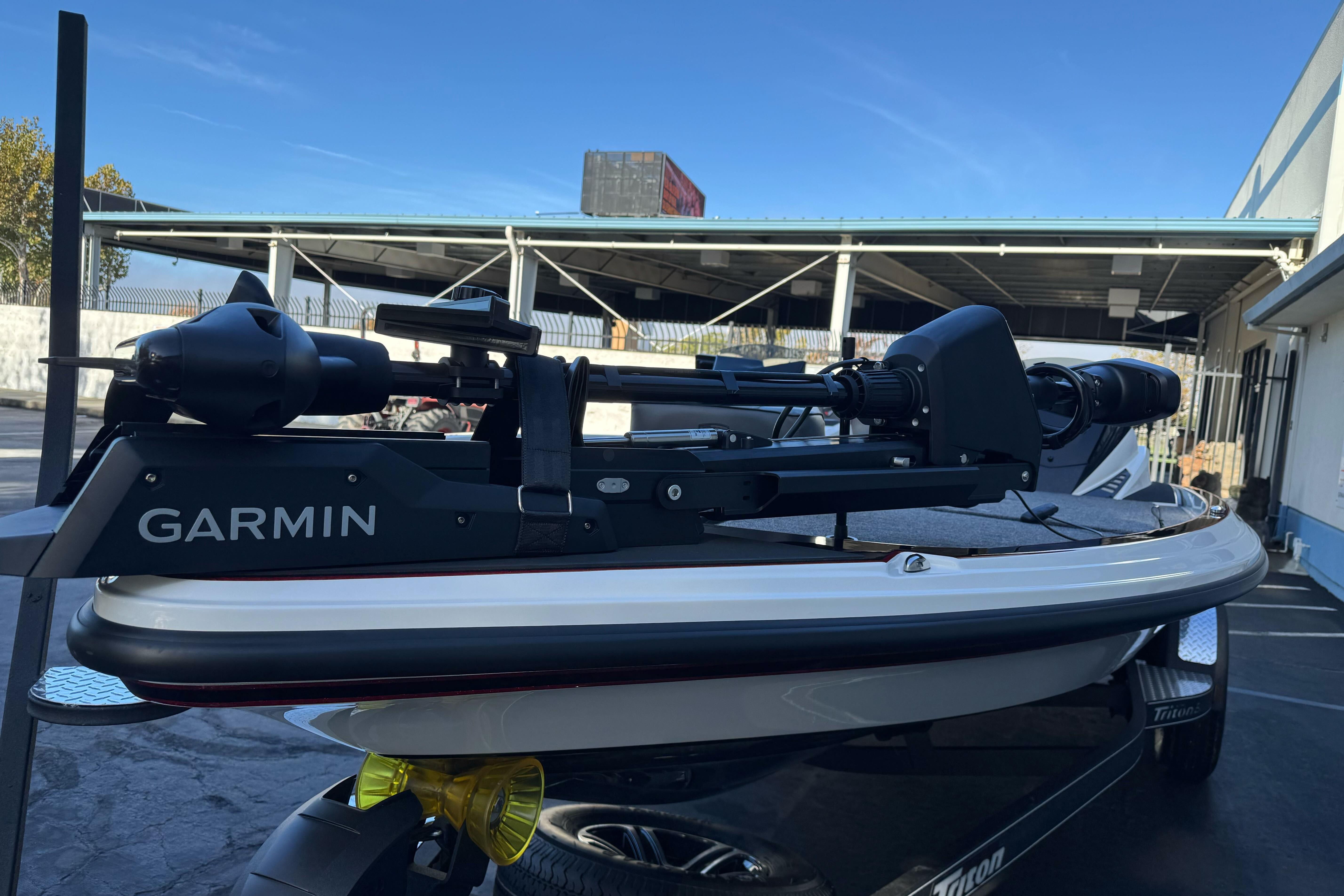 2026 Triton 20XP Patriot boat with Garmin equipment, parked outdoors.