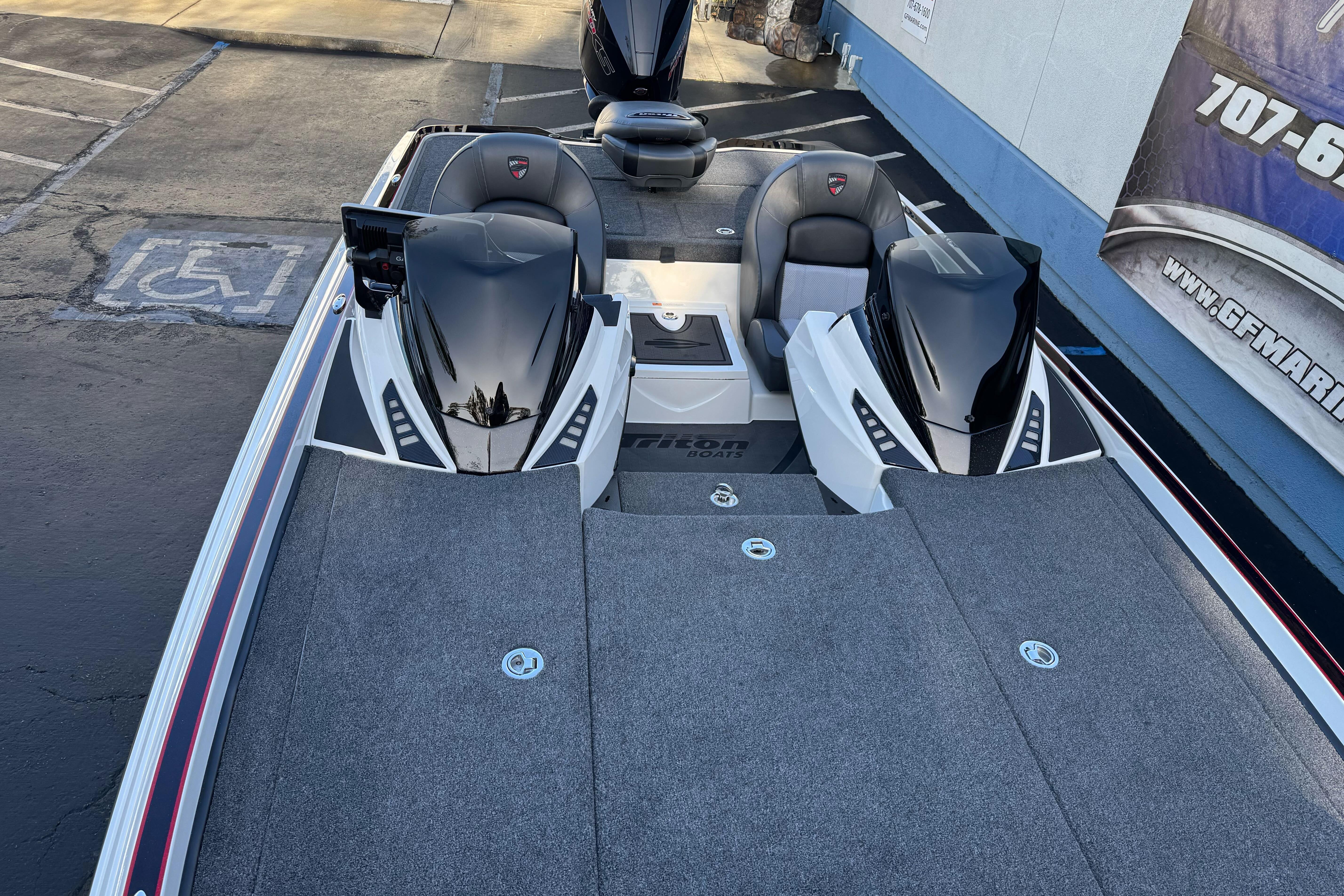 2026 Triton 20XP Patriot boat with dual seats and sleek design in a parking area.