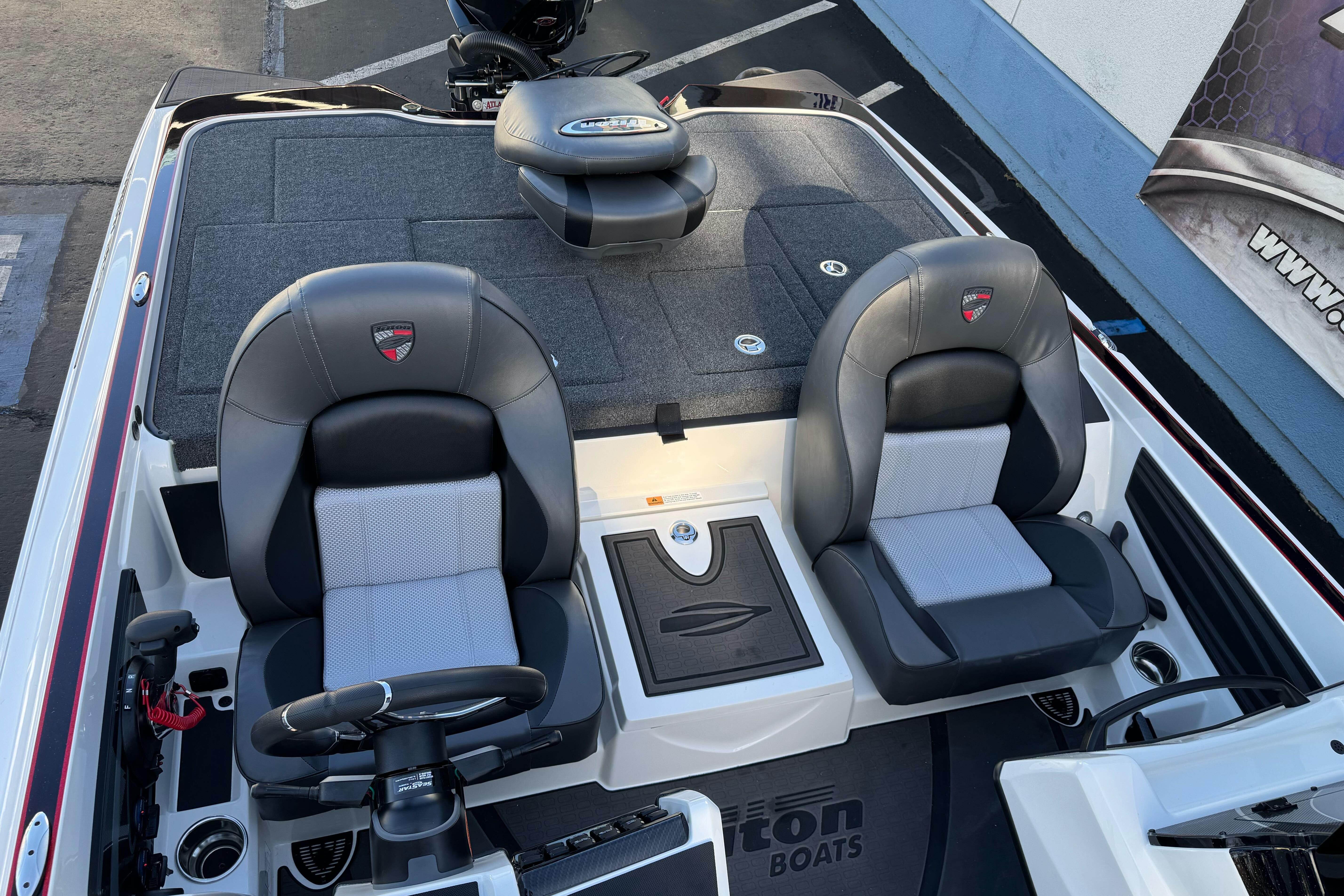 2026 Triton 20XP Patriot boat interior with dual seats and steering console.