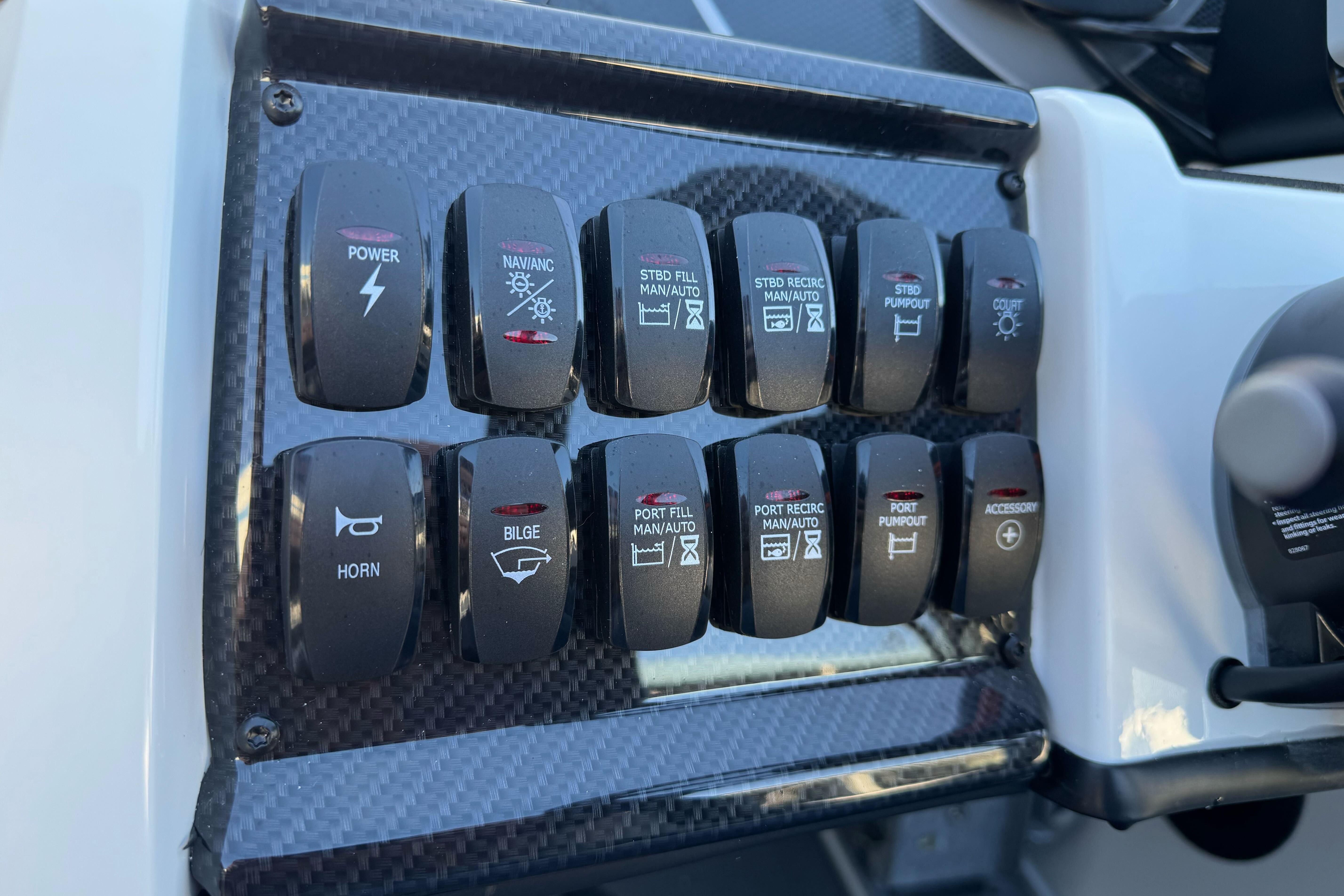 Control panel of 2026 Triton 20XP Patriot boat with labeled switches.