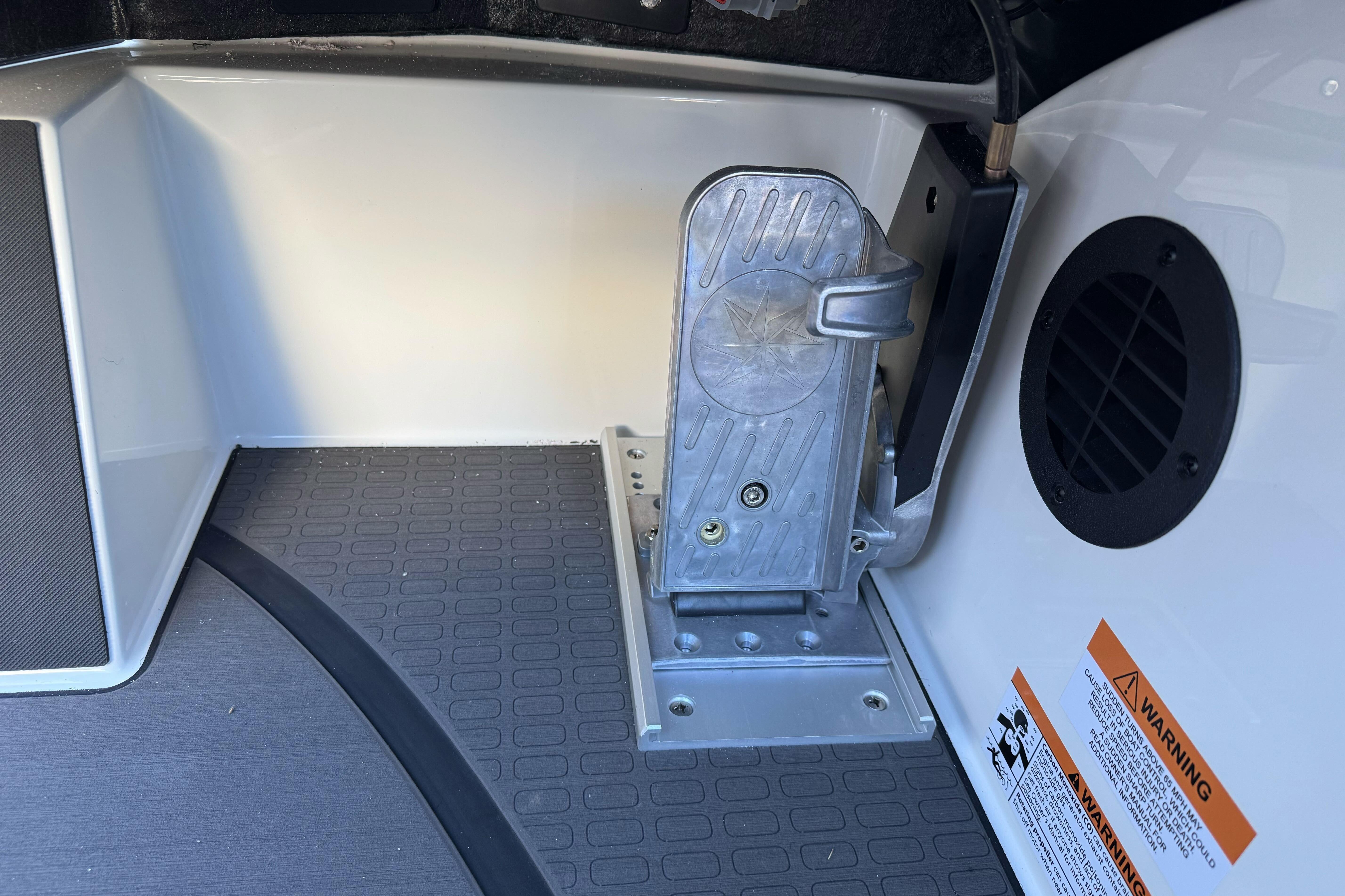Interior of 2026 Triton 20XP Patriot boat showing pedal and warning label.