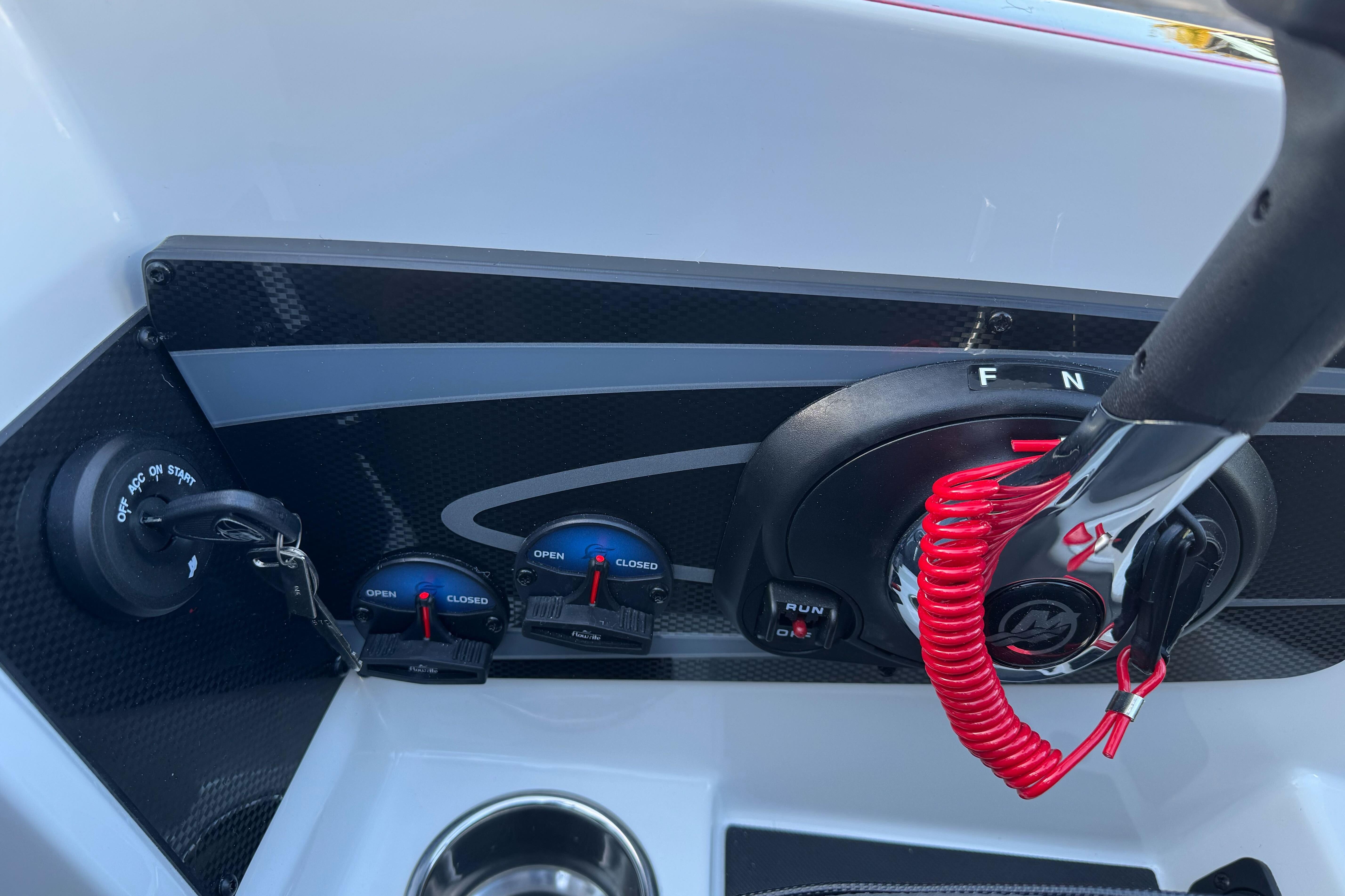 Control panel of 2026 Triton 20XP Patriot boat with ignition and throttle.