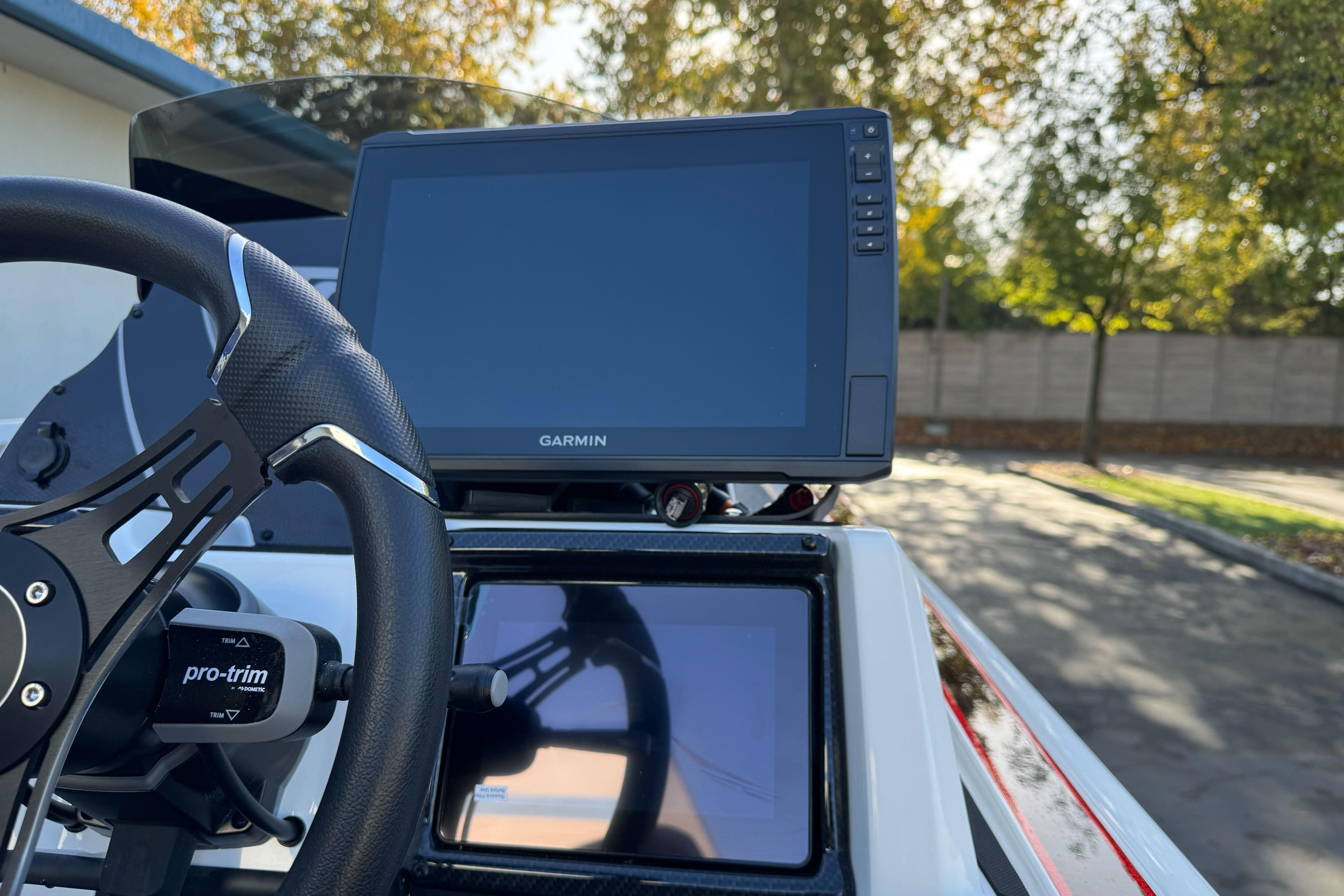 Steering wheel and Garmin display on 2026 Triton 20XP Patriot boat dashboard.