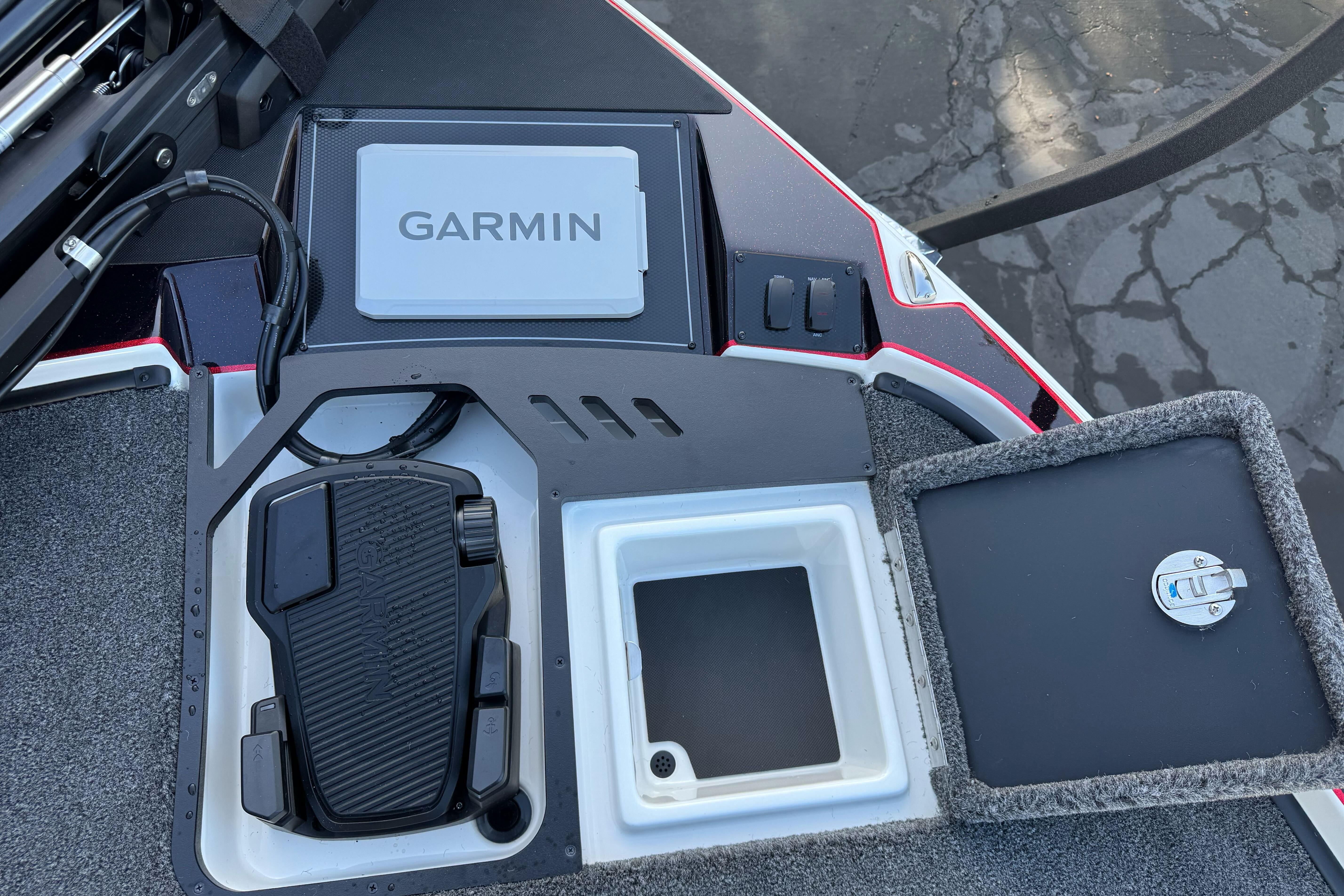 Triton 20XP Patriot 2026 boat deck with Garmin device and storage compartments.
