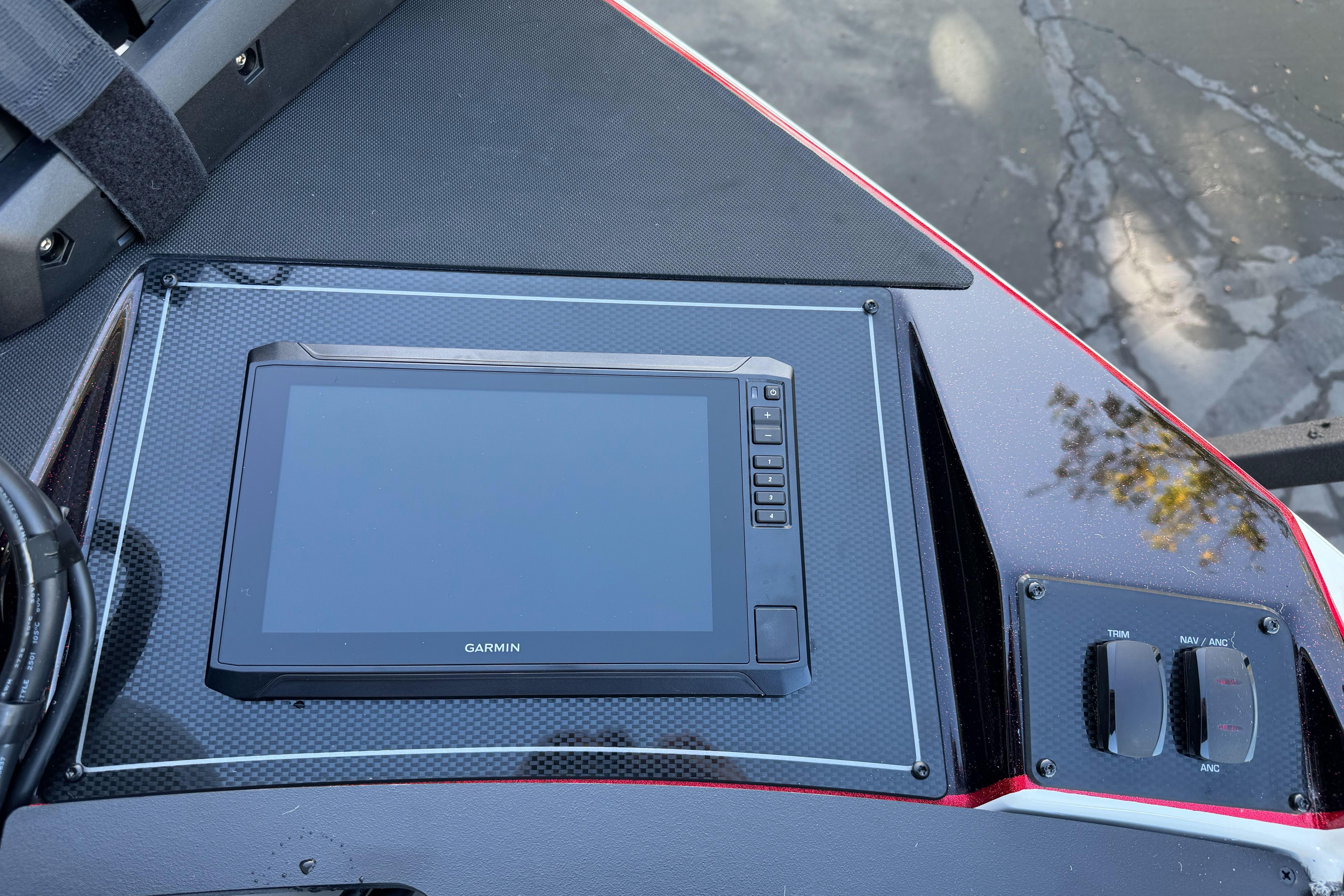 Dashboard of 2026 Triton 20XP Patriot with Garmin display and control switches.