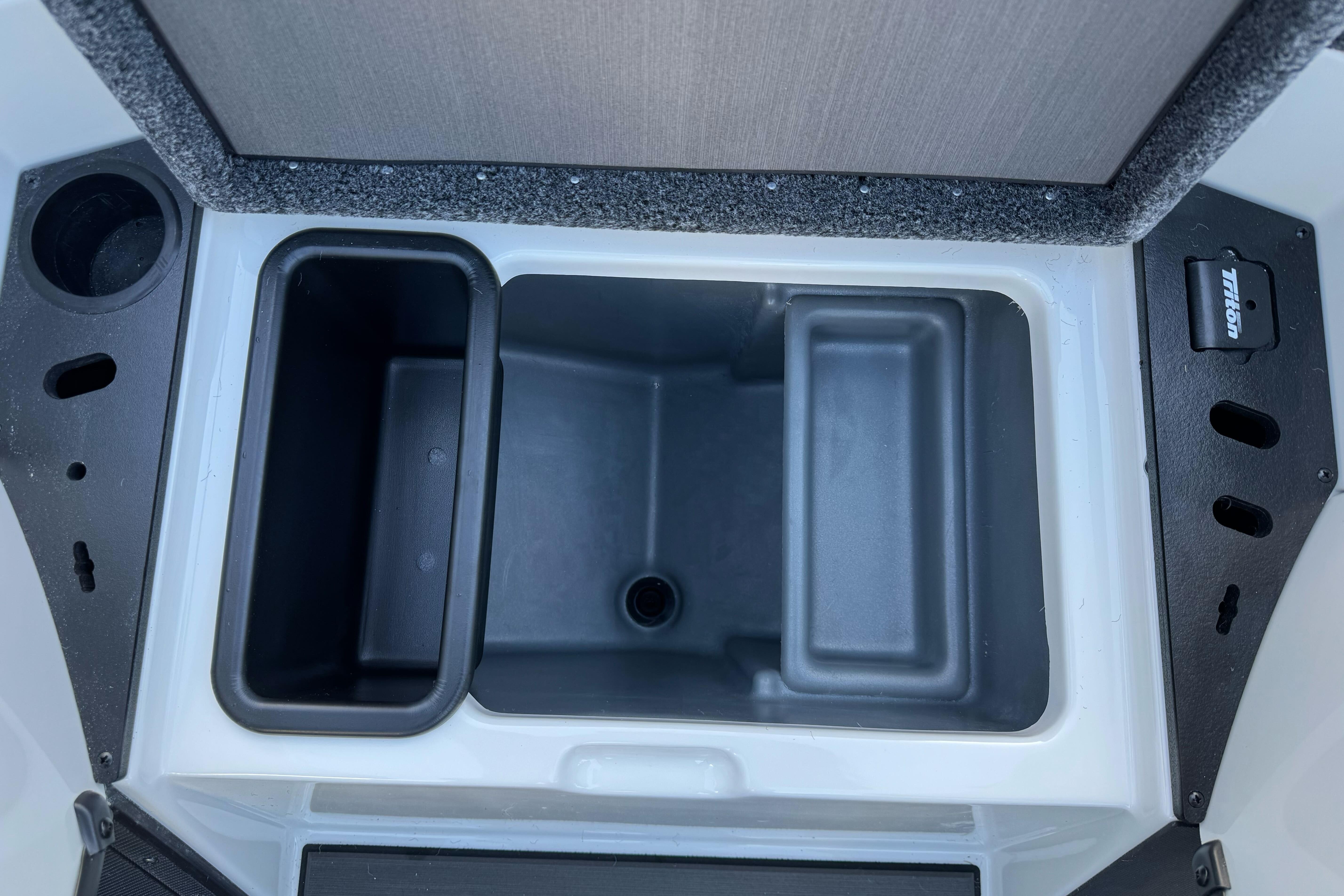 2026 Triton 20XP Patriot boat storage compartment with cup holders and drainage.