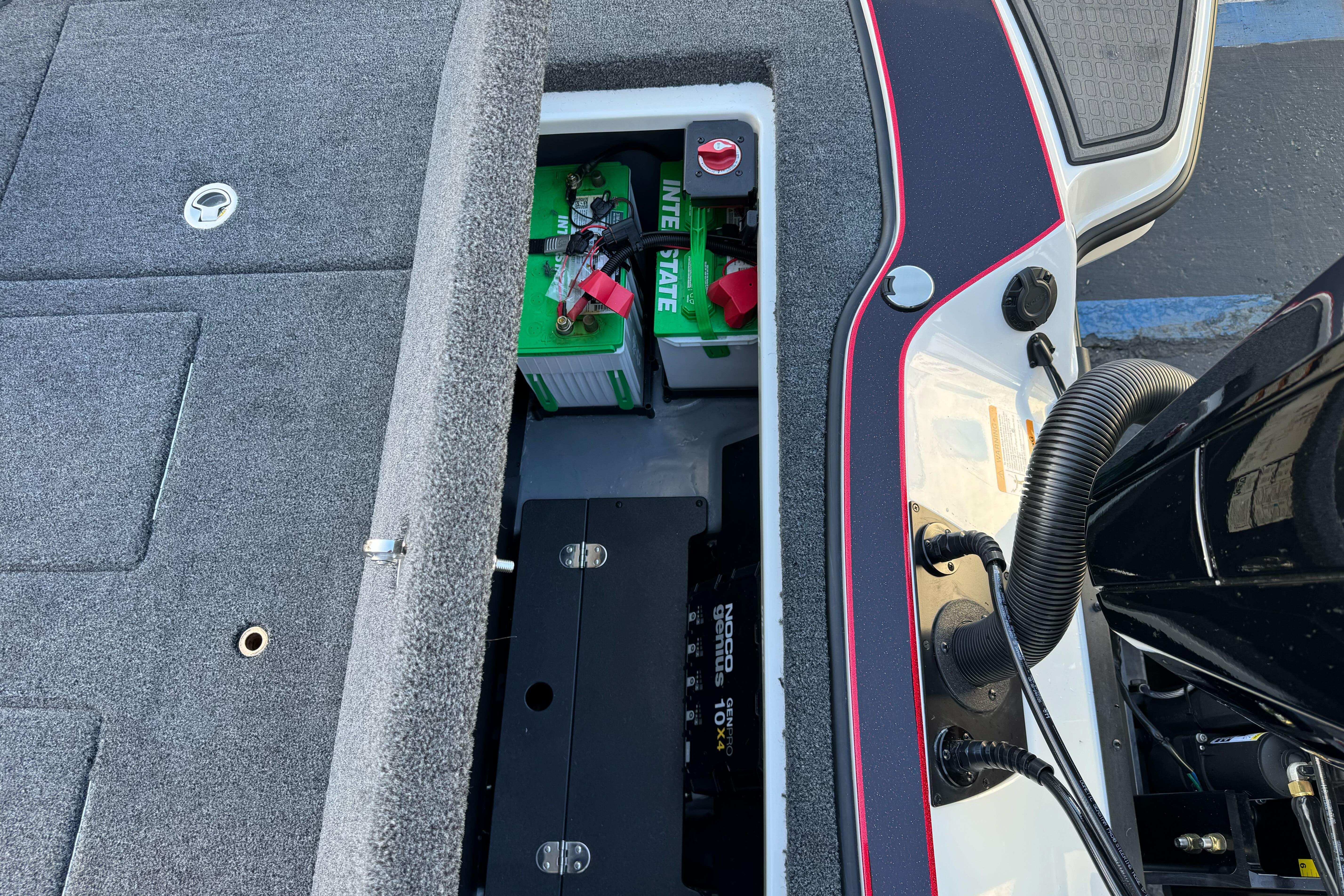 2026 Triton 20XP Patriot boat battery compartment with green battery and wiring.