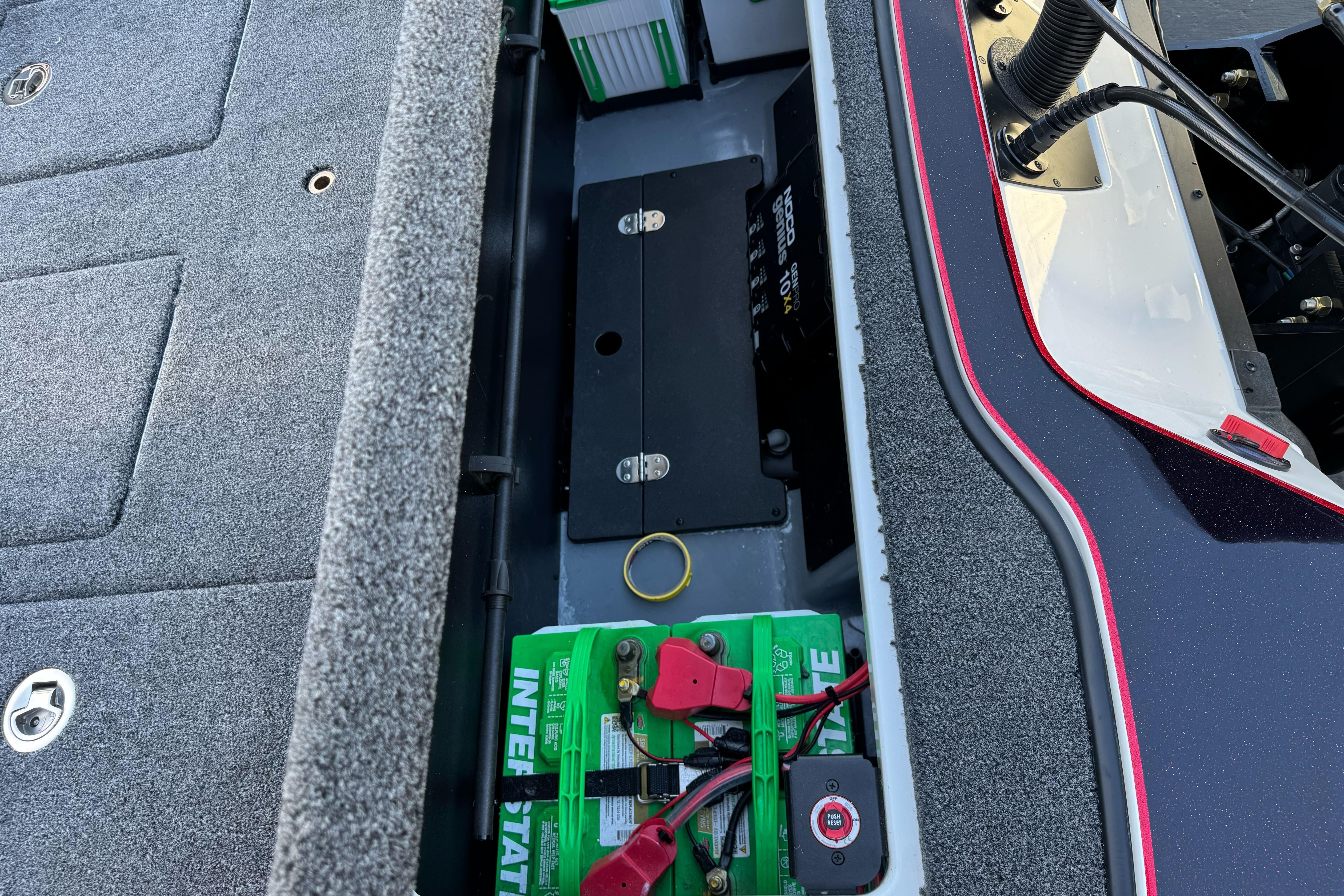 Interior view of 2026 Triton 20XP Patriot boat showing battery compartment and wiring.