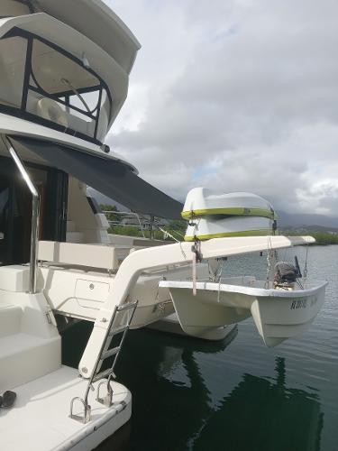 Aquila 44 yacht, 2016 model, docked with a small boat on davits.