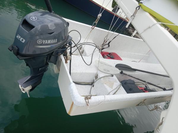Aquila 44 boat with Yamaha 20 outboard motor, docked on calm water.