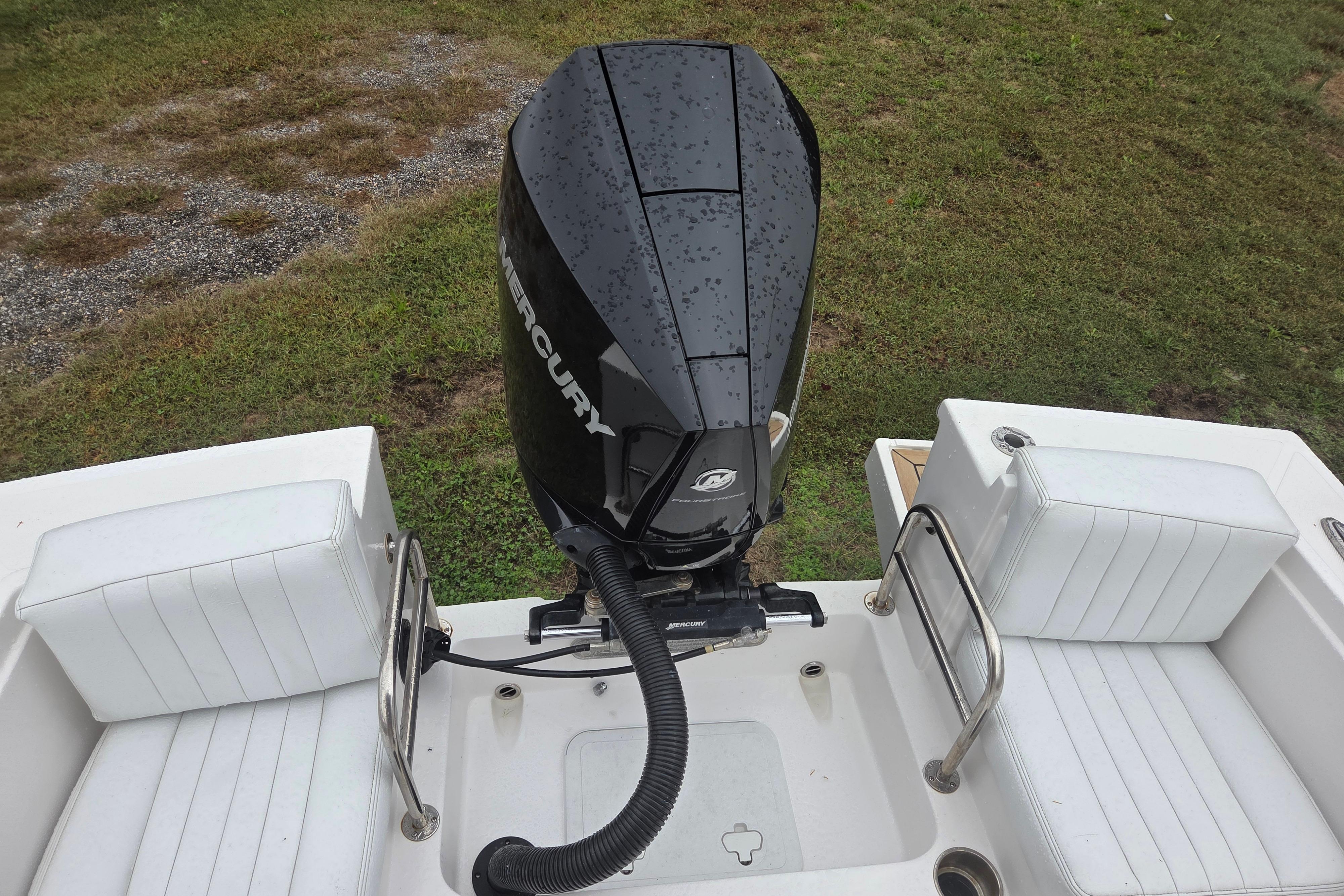 2022 Limestone L200CC boat with Mercury outboard motor and white seating.