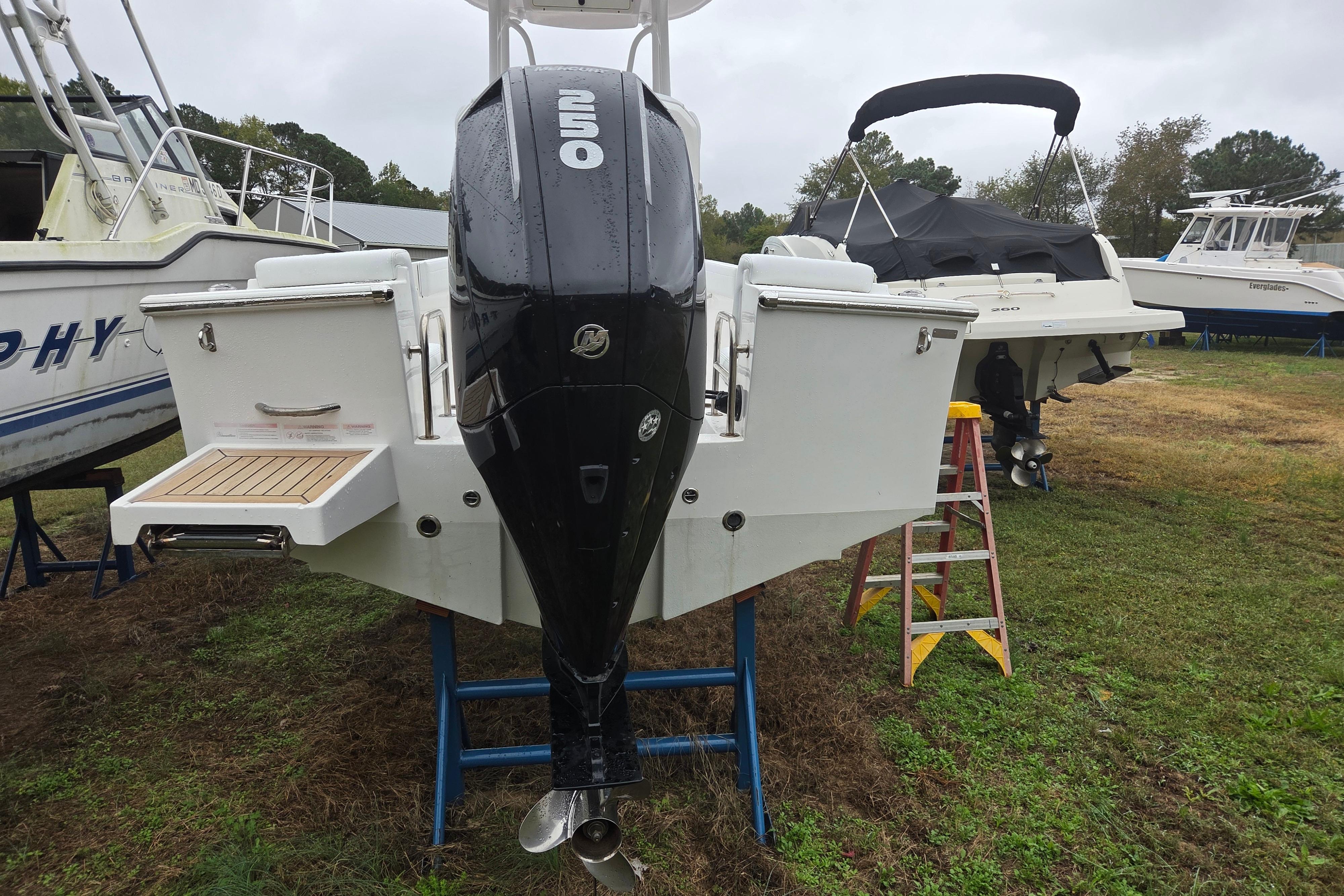 2022 Limestone L200CC boat with powerful outboard motor on display outdoors.