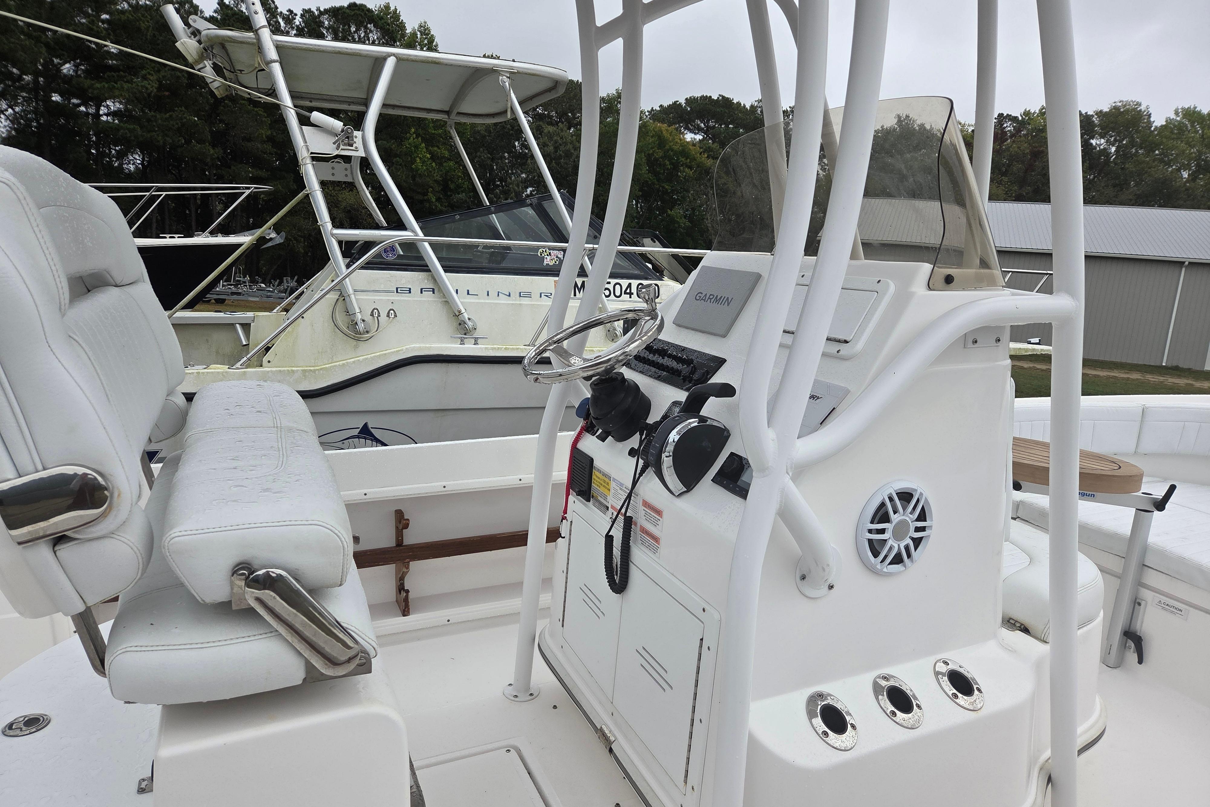 2022 Limestone L200CC boat interior with steering console and seating.