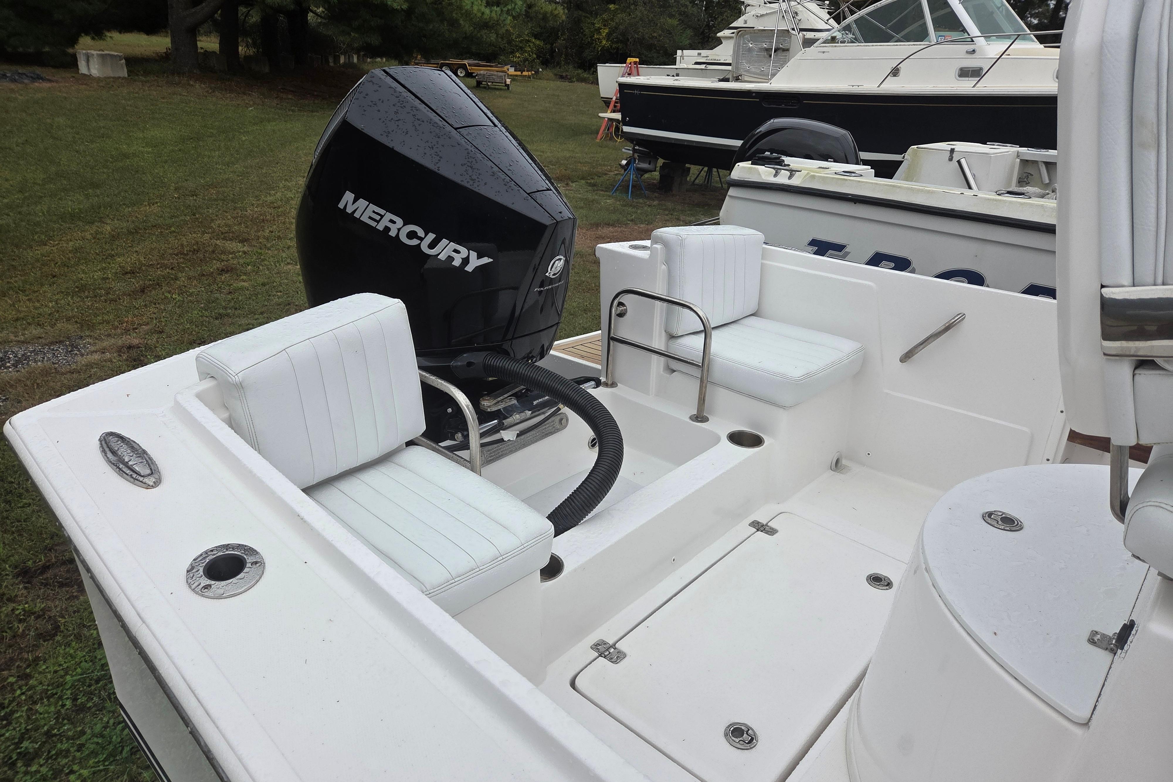 2022 Limestone L200CC boat with Mercury outboard engine, white seating, and spacious deck.