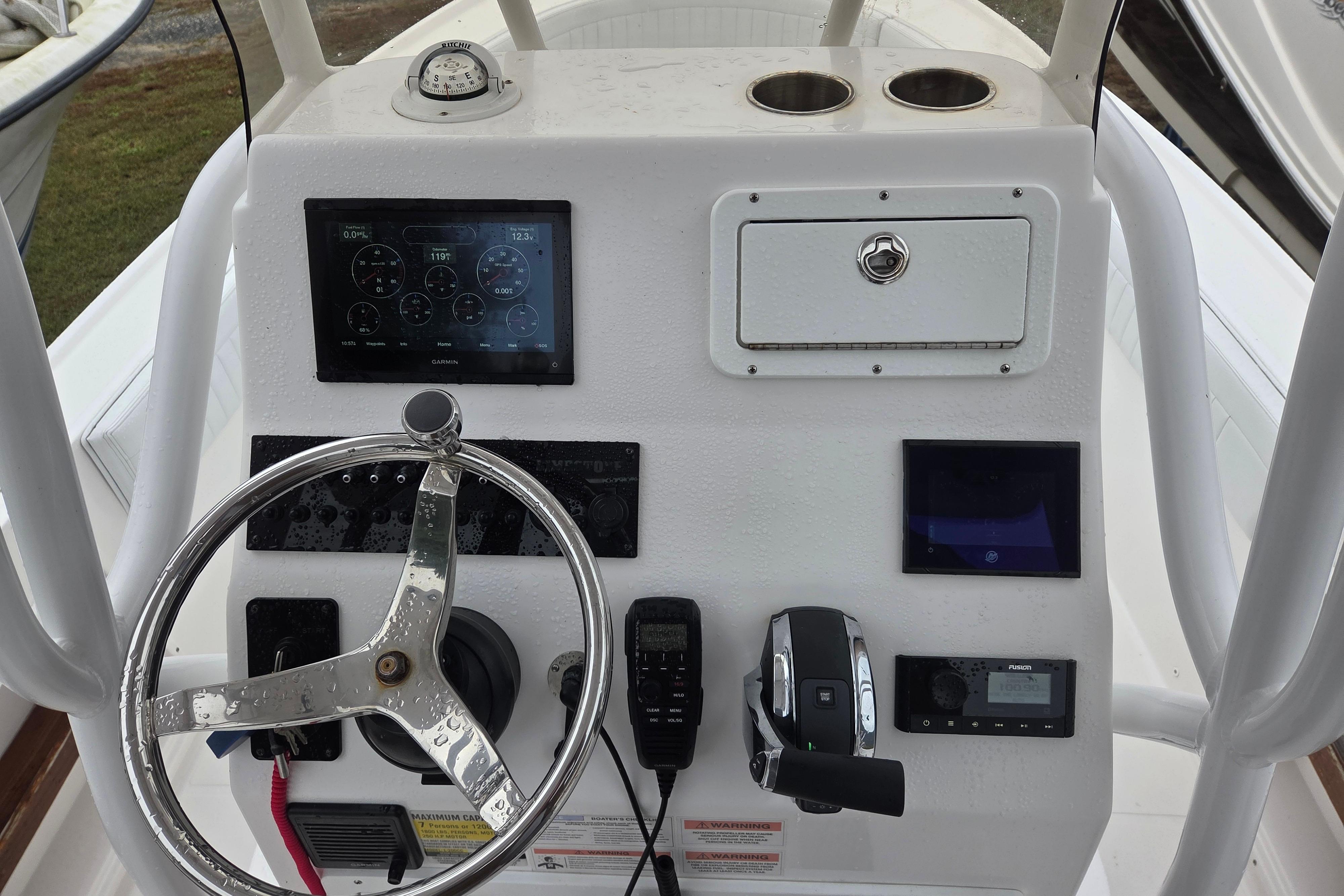 2022 Limestone L200CC boat dashboard with steering wheel and navigation controls.