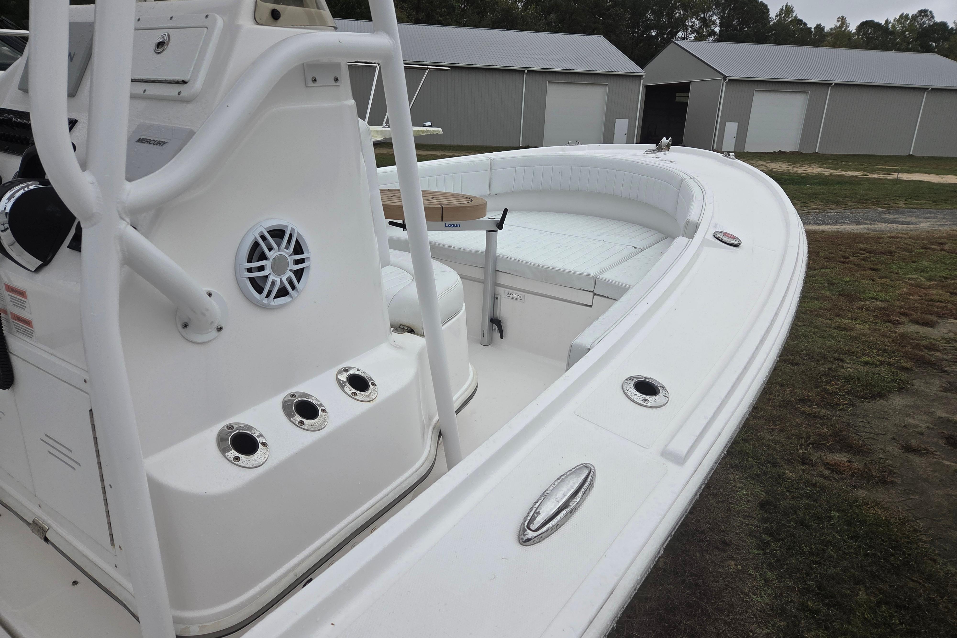2022 Limestone L200CC boat with white interior and outdoor storage buildings.