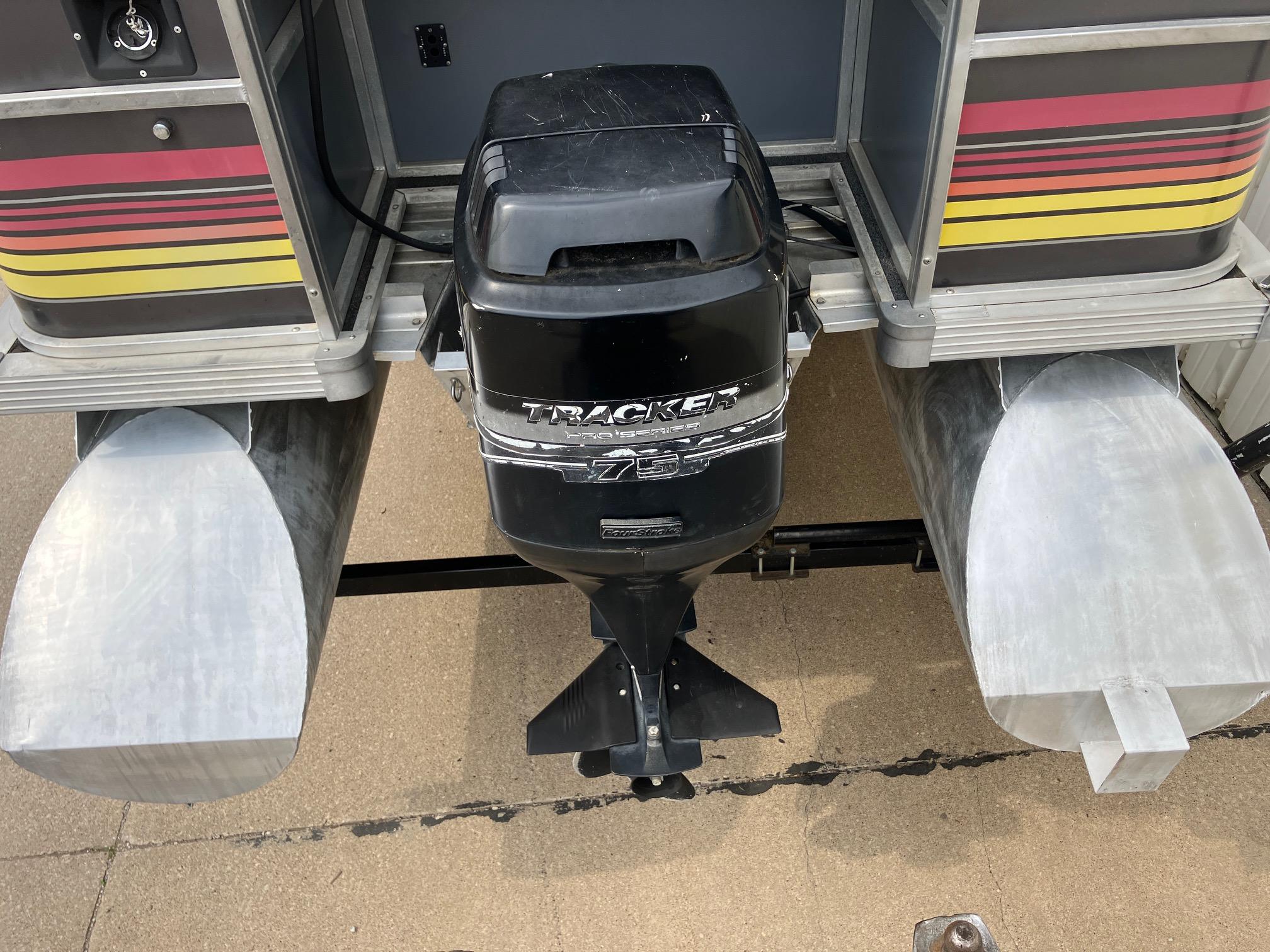 1990 Astro 24' Pontoon with Tracker outboard motor, rear view.