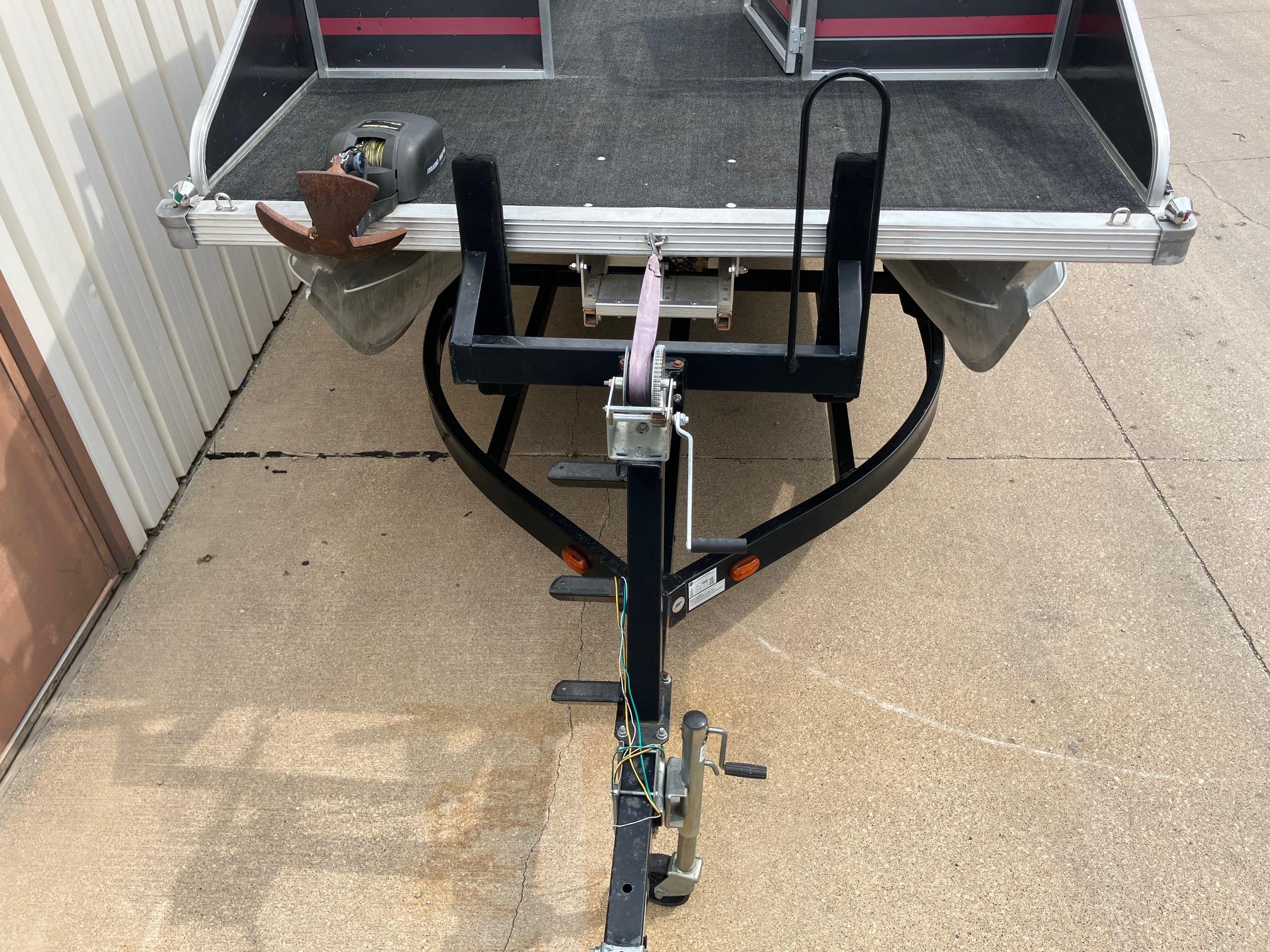 1990 Astro 24' Pontoon trailer hitch and deck, parked on concrete.