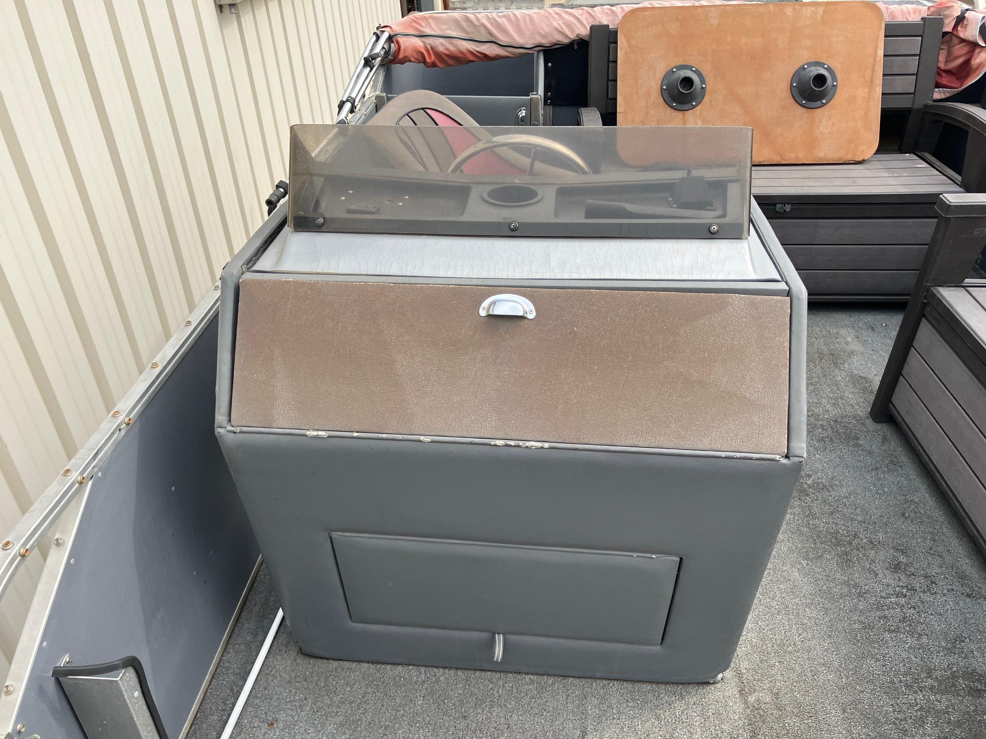 1990 Astro 24' Pontoon boat interior with steering console and seating.