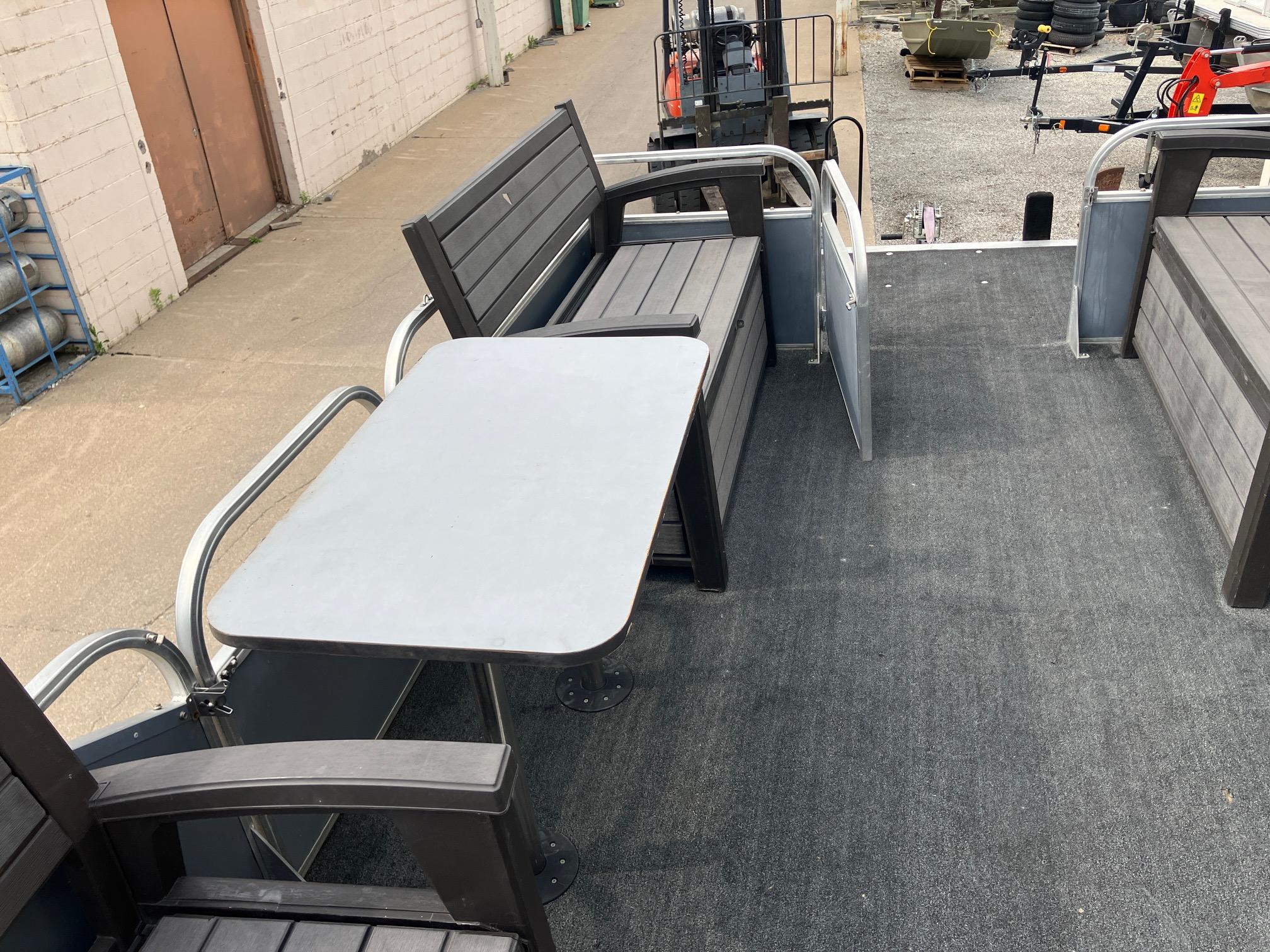 1990 Astro 24' Pontoon boat interior with seating and table on carpeted deck.