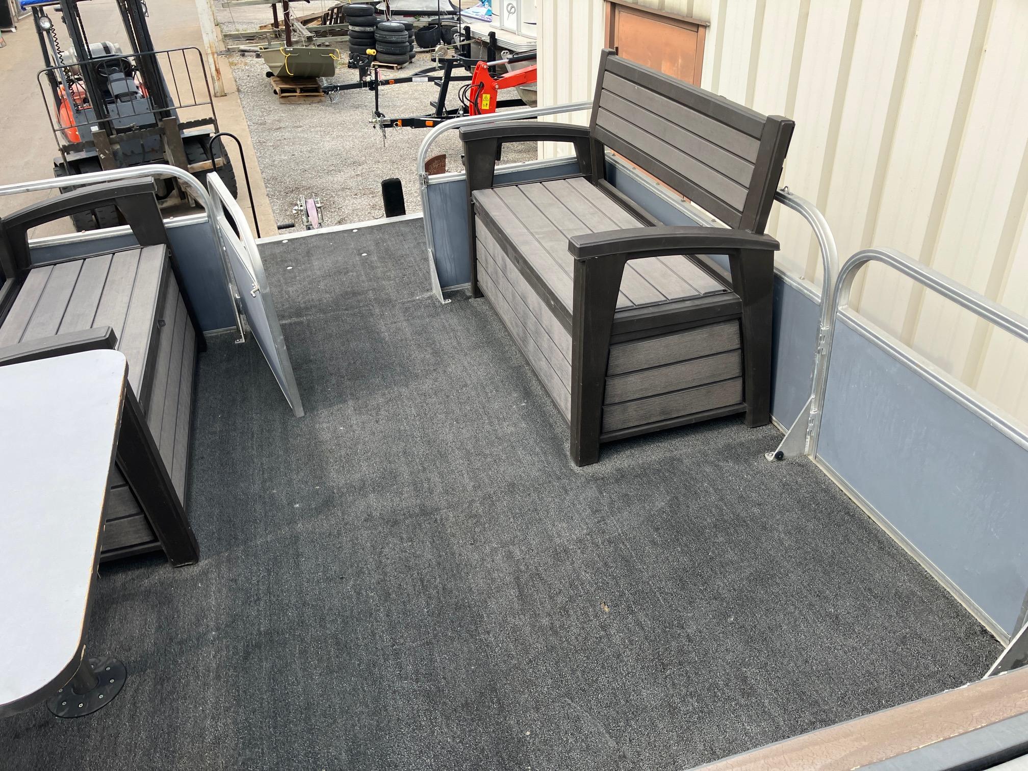 1990 Astro 24' Pontoon interior with gray seating and carpeted floor.