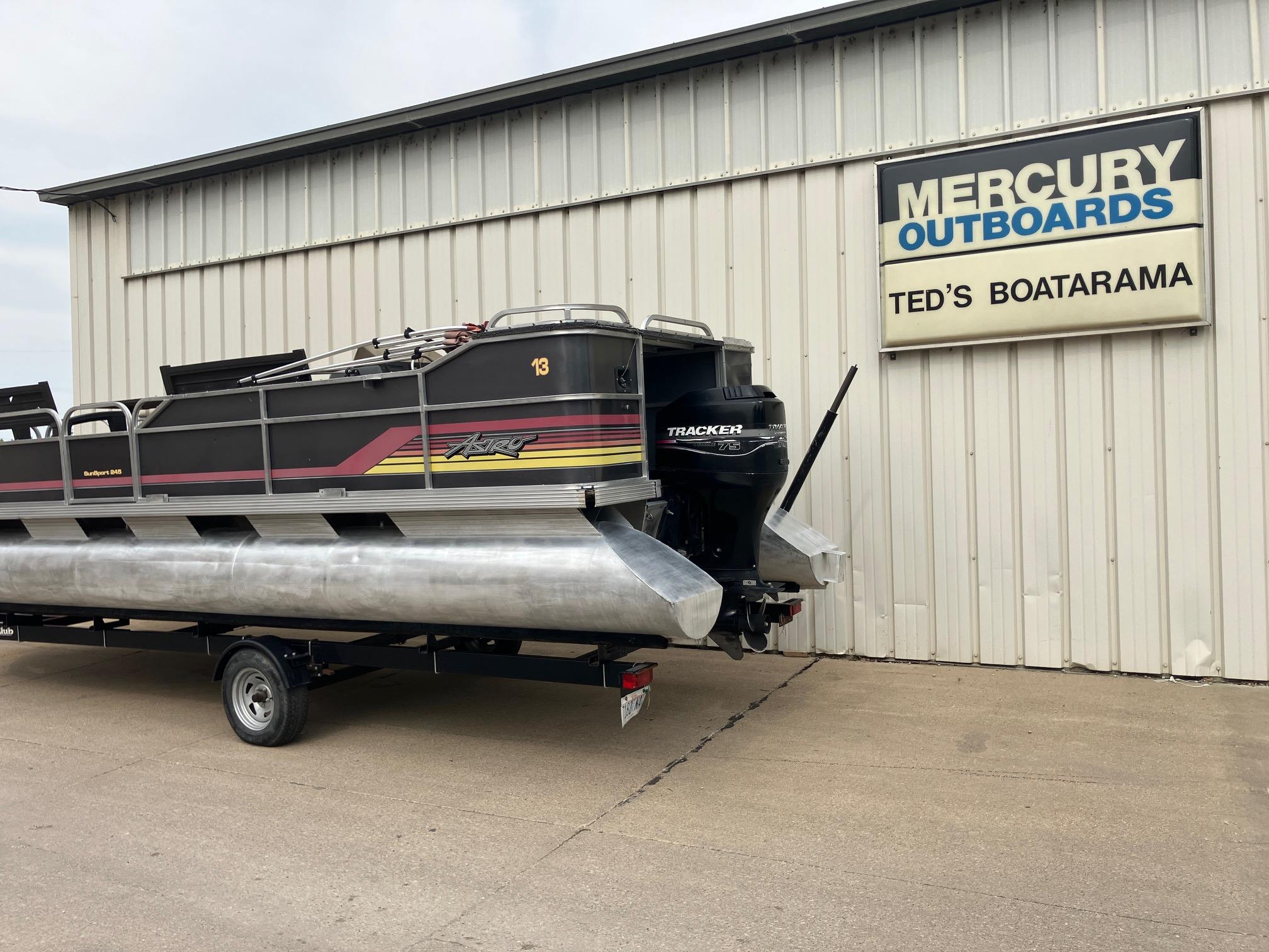 1990 Astro 24' Pontoon boat on trailer outside Ted's Boatarama.