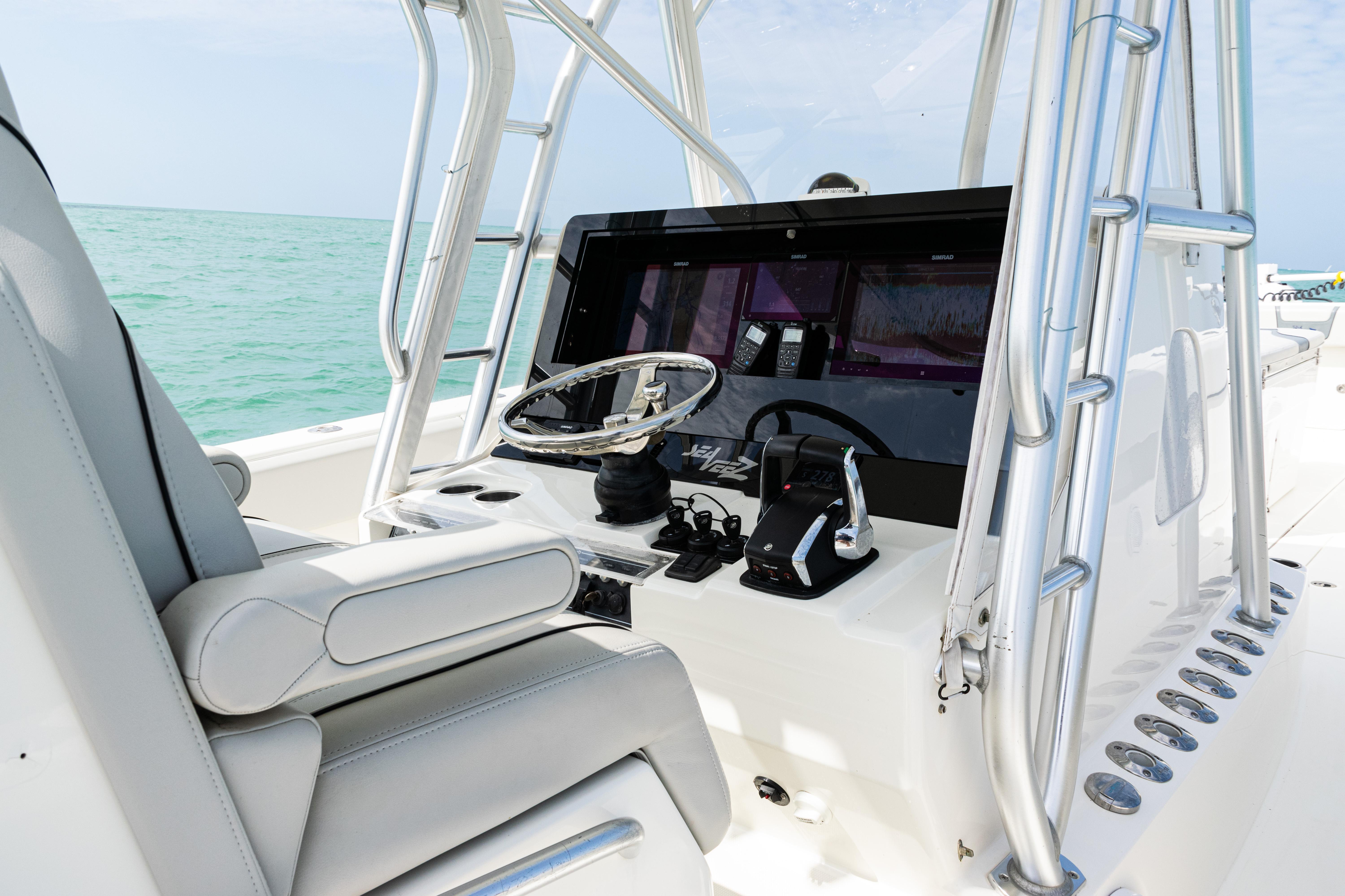 SeaVee-390Z 2015 -FL-US-2015 SeaVee 390Z boat console with steering wheel and controls, set against a turquoise sea backdrop.-9741010 | Thumbnail